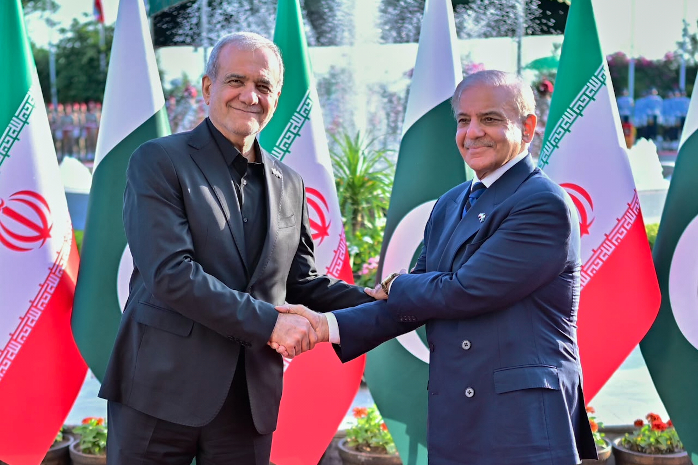 Iran's President Masoud Pezeshkian shakes hands with Pakistan's Prime Minister Shehbaz Sharif during a welcome ceremony in Islamabad on Tuesday. The U.S. and Iran were in a dispute over nuclear site inspections, as a plan emerged to break the bottleneck in the Strait of Hormuz.