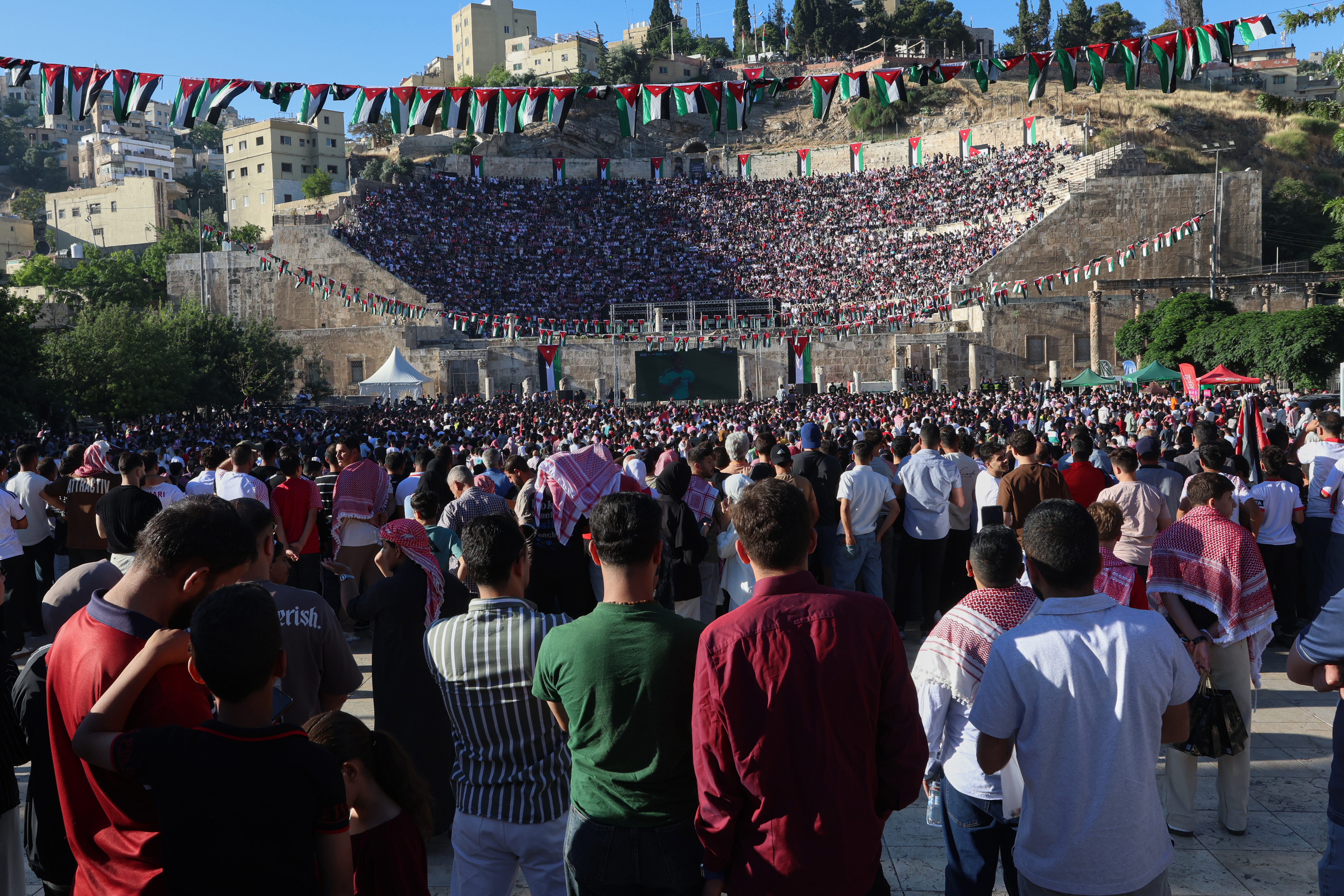 Jordanian soccer fans watch the World Cup match between Jordan and Austria on a large screen at the Roman Amphitheater in downtown Amman, Jordan, early Wednesday, June 17, 2026.