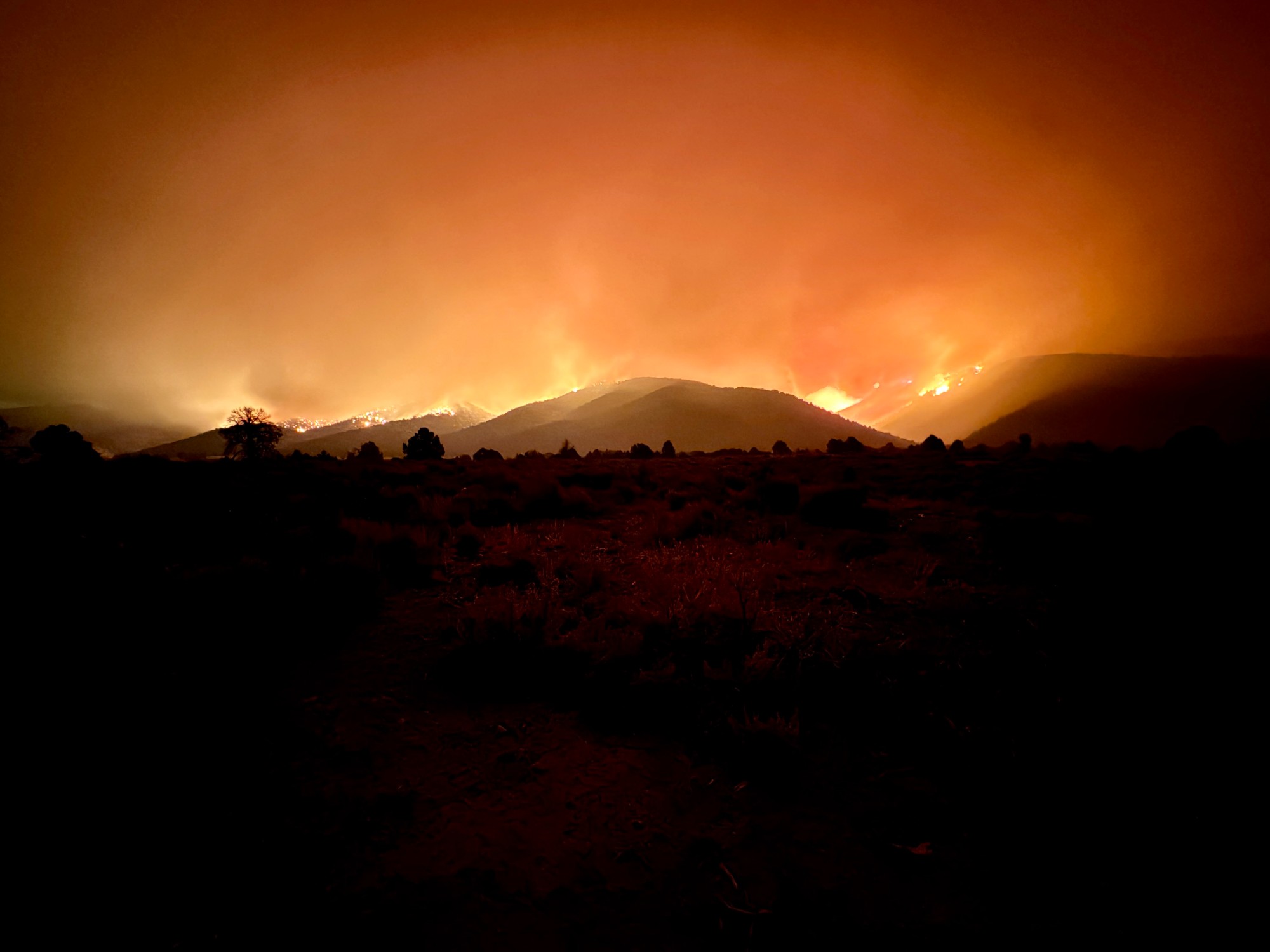 The Iron Fire's smoke columns, sunset glow and night sky seen from the north side of the fire in Juab County on Sunday.