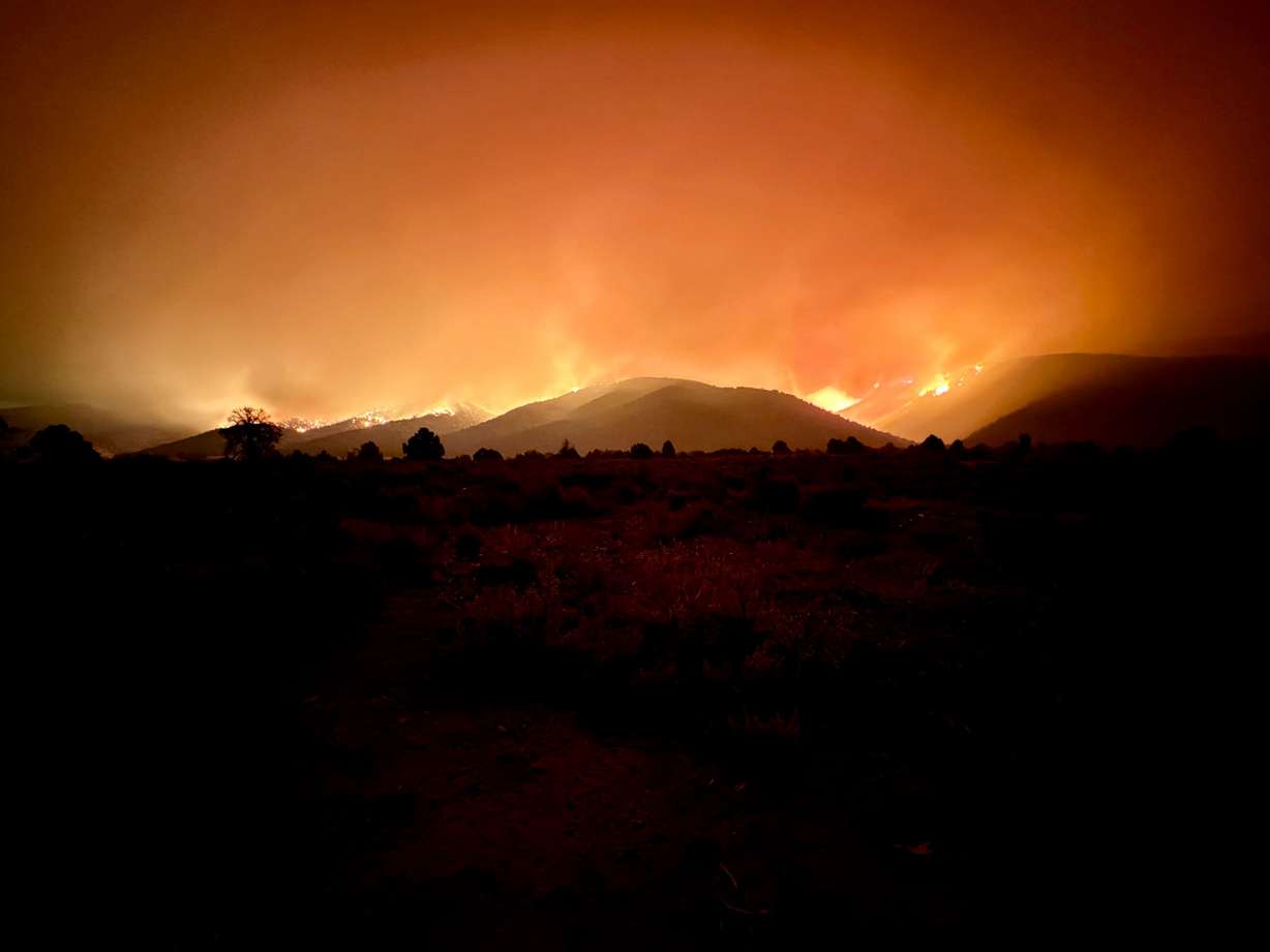 The Iron Fire's smoke columns, sunset glow and night sky seen from the north side of the fire in Juab County on Sunday.