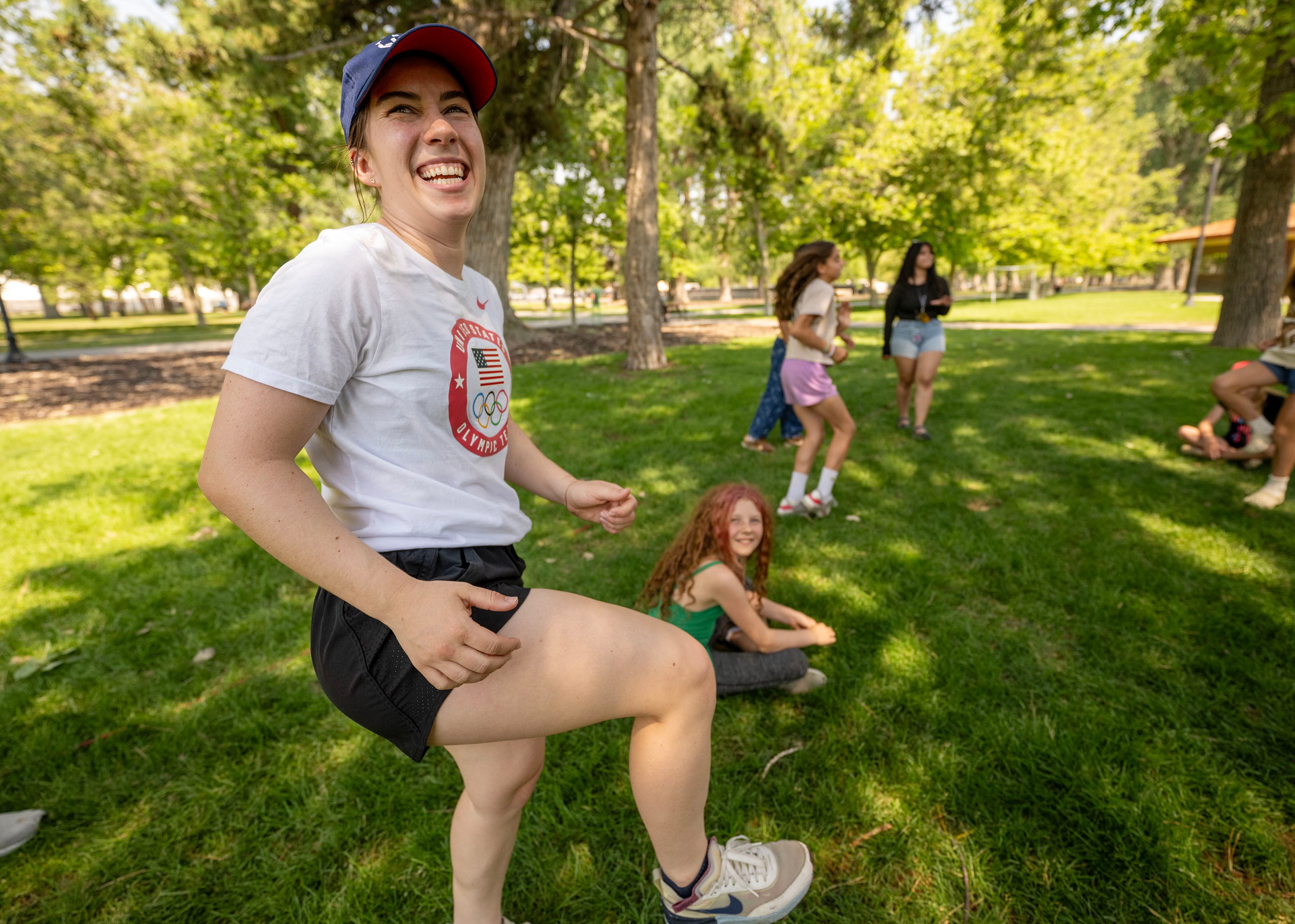 Julie Letai, short track speedskating, smiles as she joins with other Olympic and Paralympic athletes from the 2026 Milan Cortina Winter Games to celebrate global Olympic Day with a morning of workouts with the kids at Salt Lake City’s YouthCity program at Liberty Park in Salt Lake City on Tuesday.