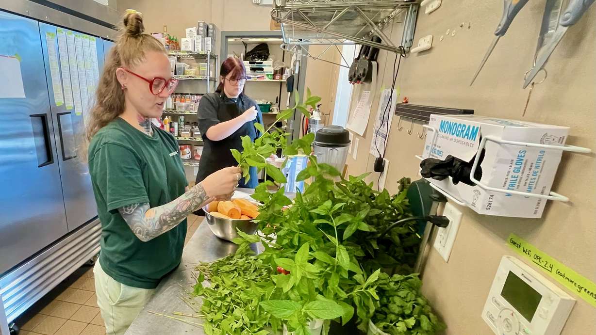 Ogden restaurant operator Steve Ballard is spearheading an initiative to promote healthy eating through $3.95 curry bowls offered at the Ogden Produce Co. Employees Opal Spring, left, and Miya Ruth are pictured at the locale on June 10.