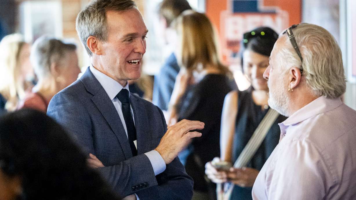 Ben McAdams, a candidate for Utah's 1st Congressional District, talks with an attendee at a watch party for McAdams during Utah’s primary election at Publik Coffee Roasters on Tuesday.