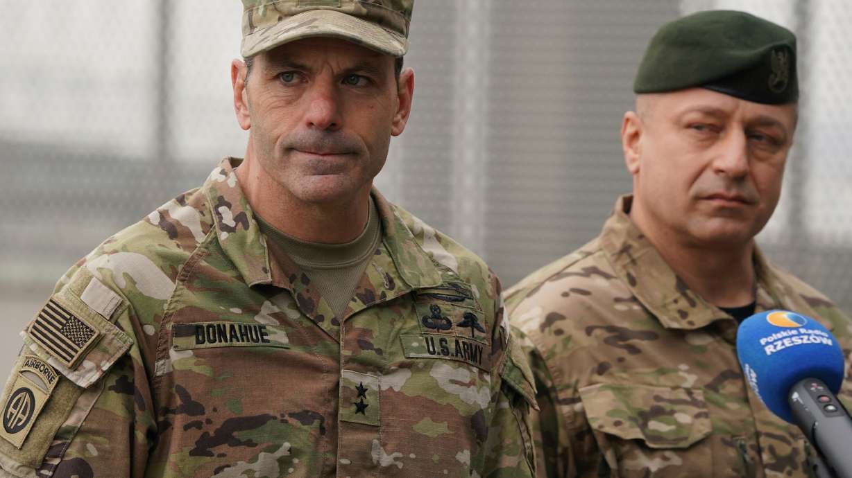U.S. Army Gen. Christopher Donahue and Polish General Wojciech Marchwica speak at the Rzeszów-Jasionka airport in southeastern Poland, Feb. 6, 2022. Donahue will relinquish his command on July 2, a statement released on Tuesday said.