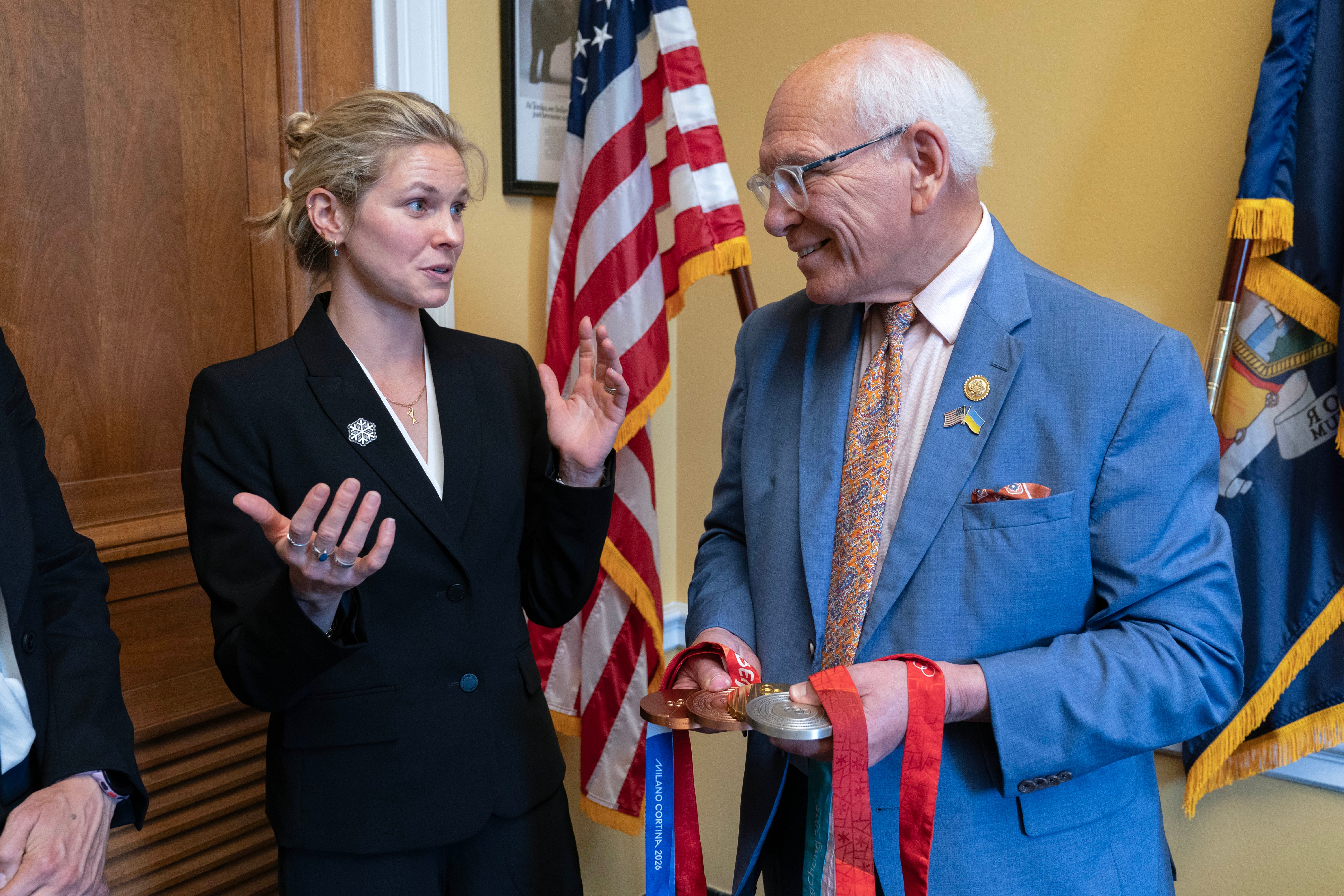Rep. Paul Tonko, D-N.Y., speaks with Olympian Jessie Diggins as she shows him her medals during a meeting to advocate for clean air, clean water and a healthy planet on Capitol Hill Tuesday, June 23, 2026, in Washington.