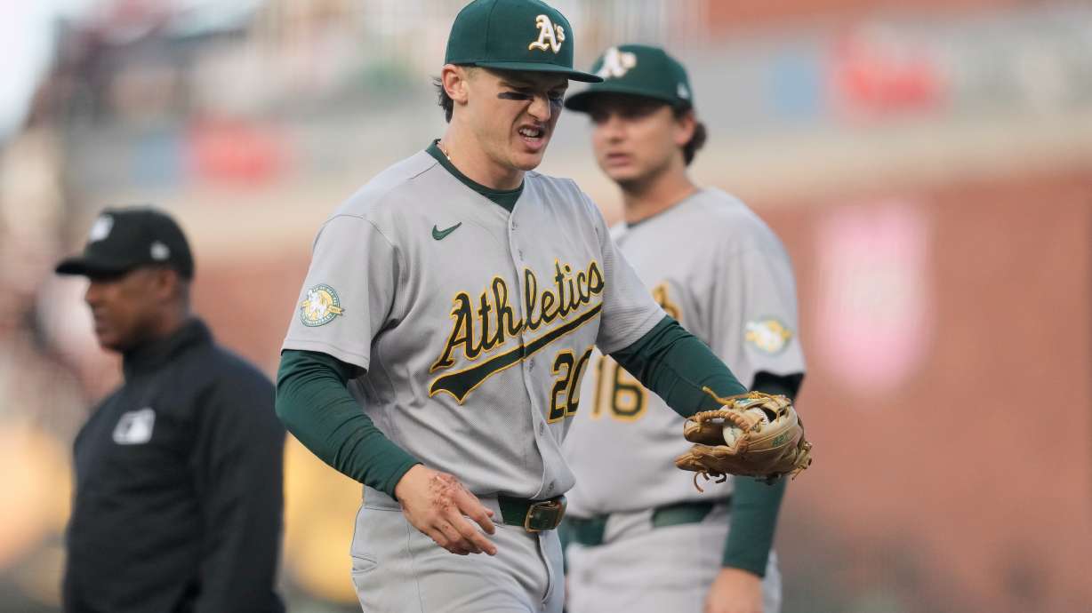 Athletics second baseman Zack Gelof, left, reacts as he walks off the field during the second inning of a baseball game against the San Francisco Giants Tuesday, June 23, 2026, in San Francisco.