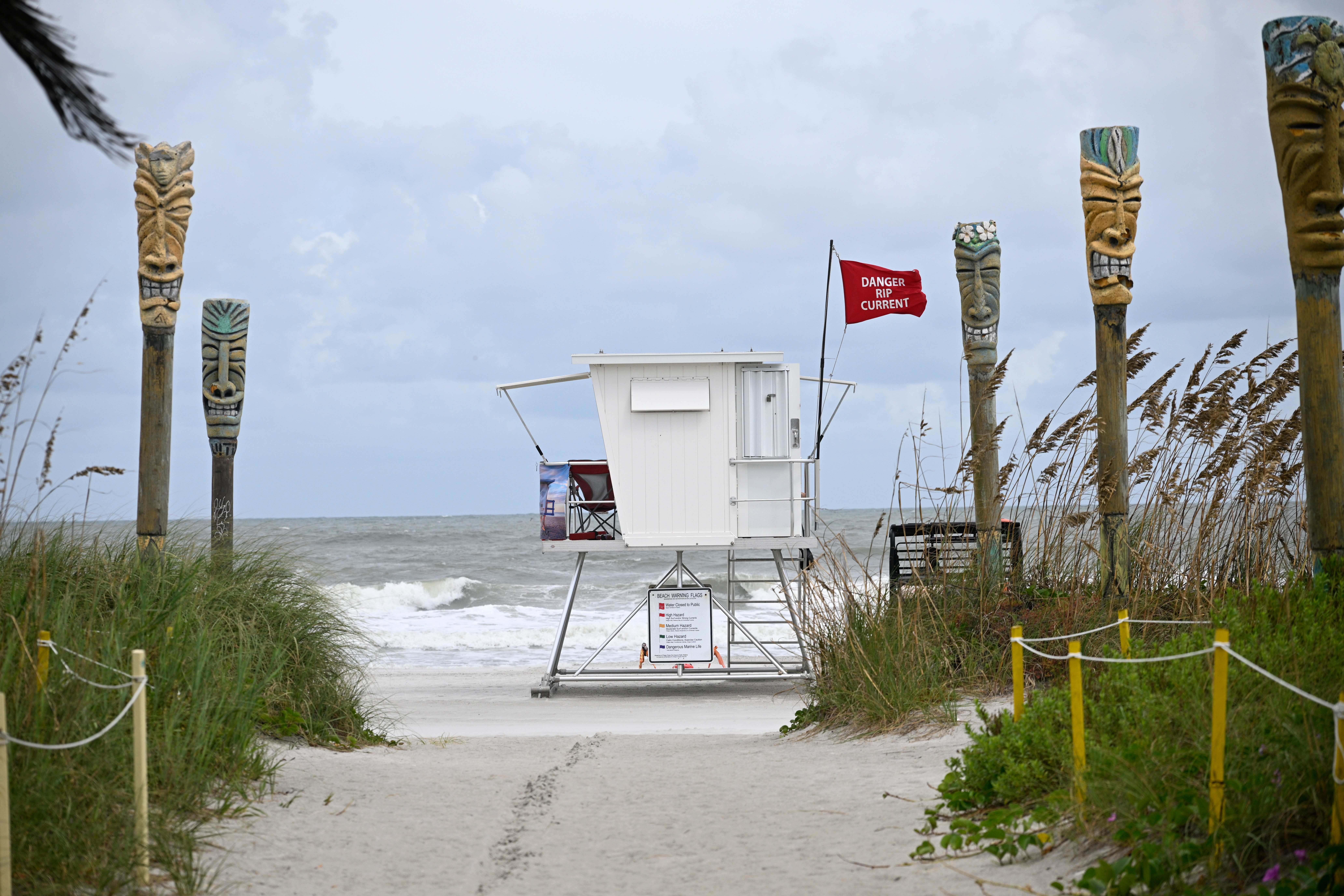 A "Danger Rip Current" flag flies as Tropical Storm Imelda passes offshore Sept. 29, in Cocoa Beach, Fla. Lifeguards say to not only not panic when caught in a rip current, but to flip over and float out of the danger.