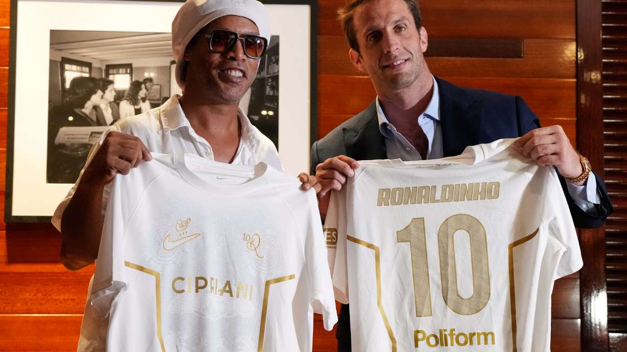 Brazilian football legend Ronaldinho, left, holds up jerseys along with Ignazio Cipriani, president of Ravenna FC, at a media event celebrating Ronaldinho's recent signing with the Italian soccer club, at Cipriani Downtown Miami restaurant, Tuesday, June 23, 2026, in Miami.