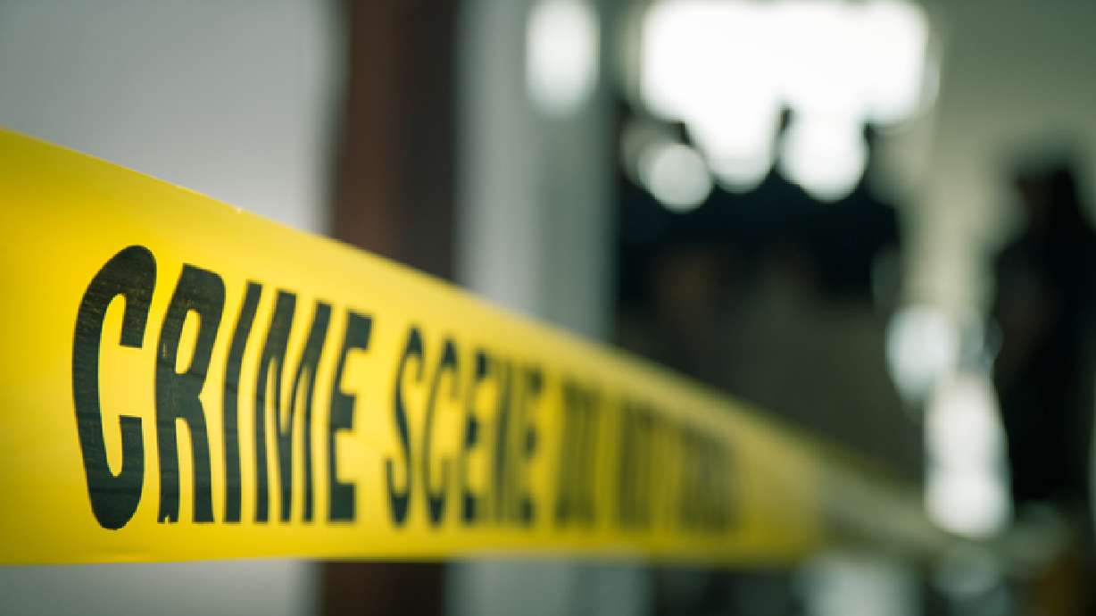 crime concept by police line tape with blurred forensic law enforcement background in cinematic tone and copy space