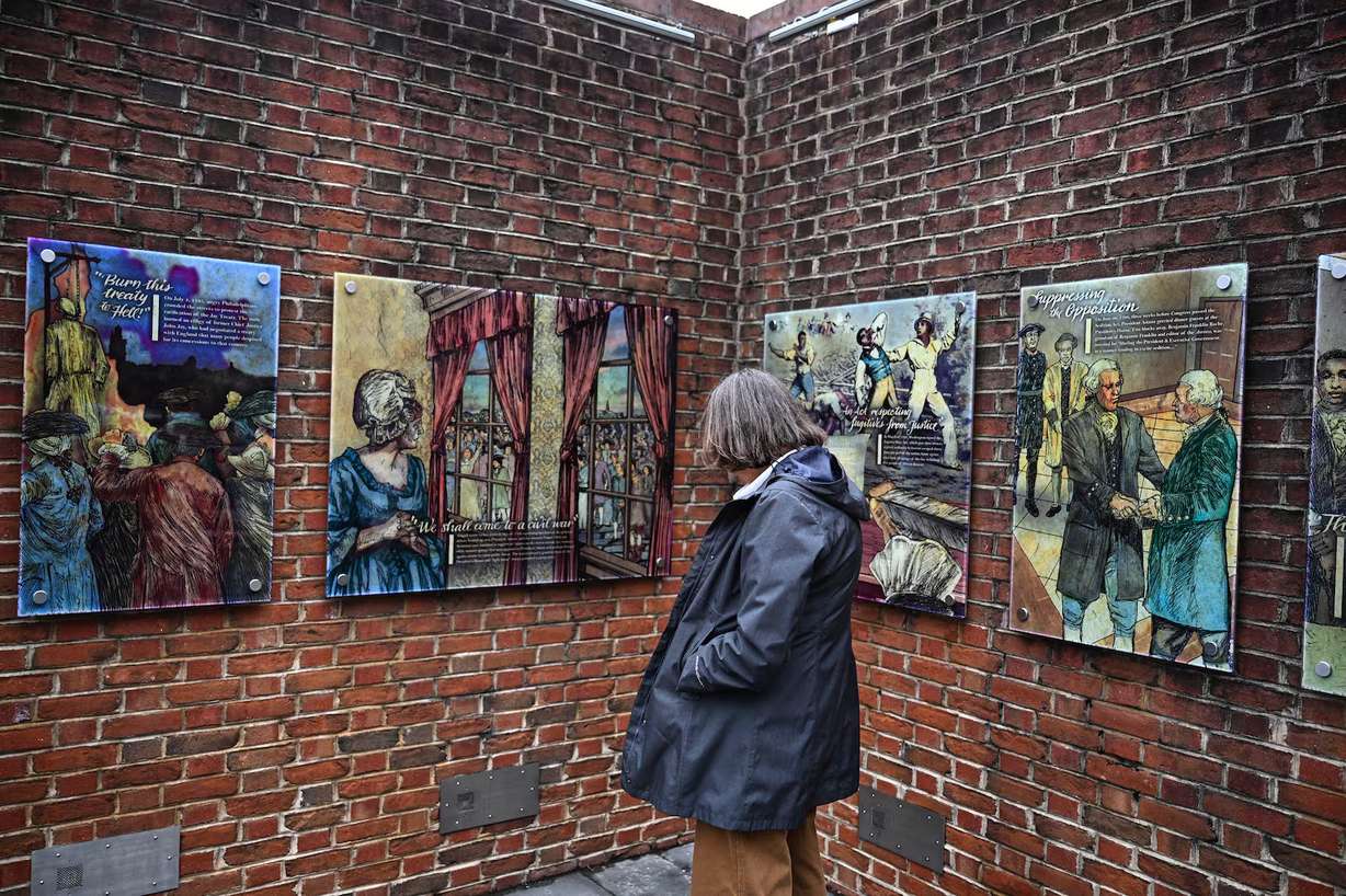 A person views panels that were part of an exhibit on slavery at the President's House Site in Philadelphia after they are put back, Feb. 19. An overwhelming amount of Americans want uncomfortable truths to remain part of national parks.