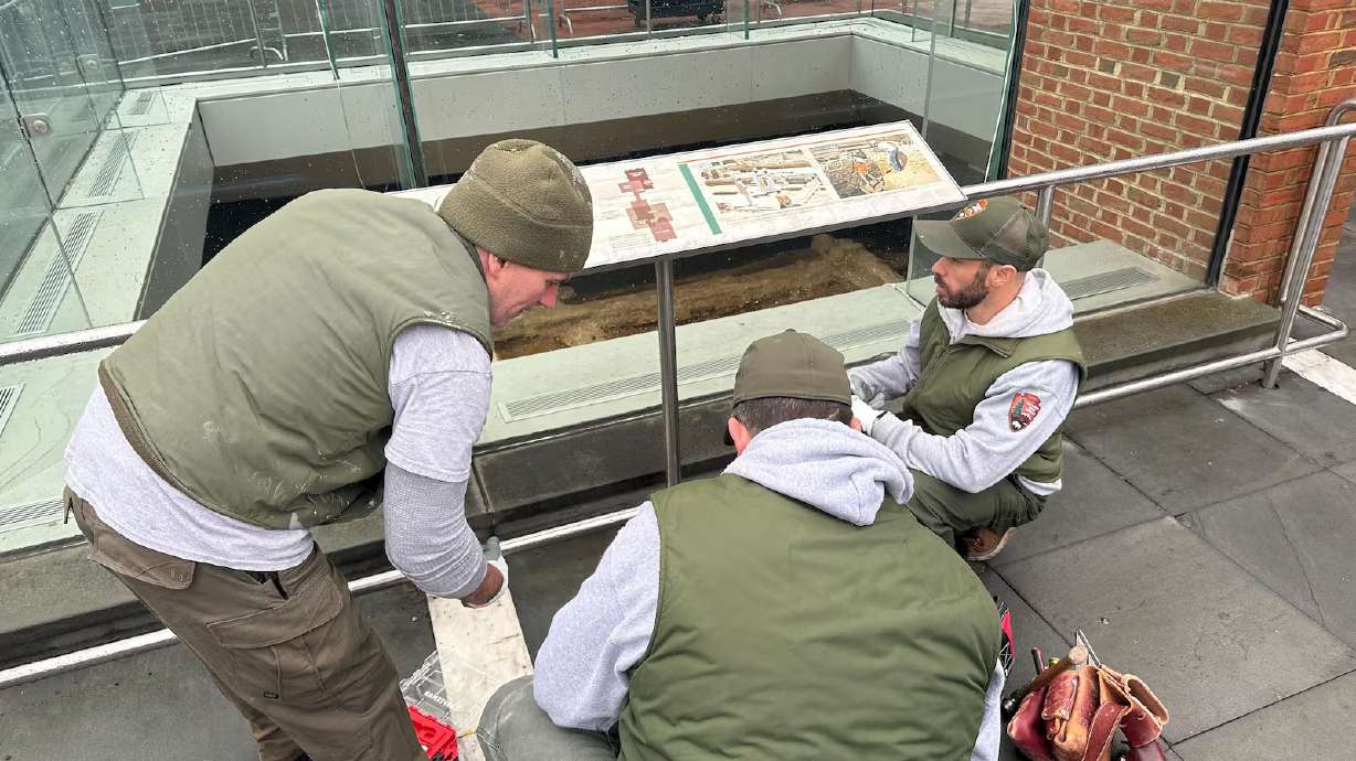 National Park Service employees reinstall parts of a slavery exhibit detailing the lives of nine people enslaved by President George Washington despite an ongoing legal fight between the city and the Trump administration, Feb. 20 in Philadelphia. Conservation groups are pushing back on President Donald Trump's effort to change how history presented on public lands.