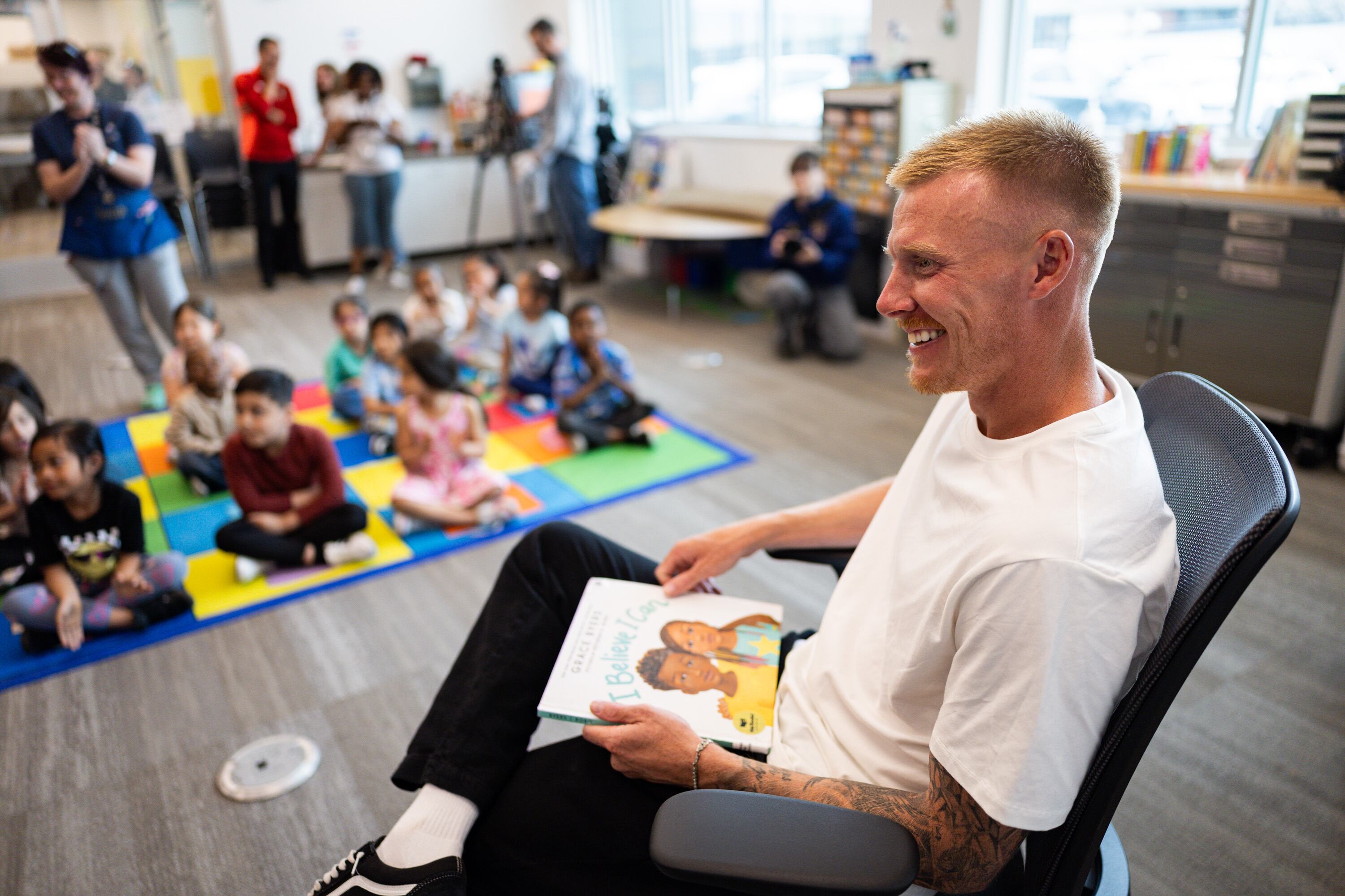 Real Salt Lake player Justen Glad reads aloud to kindergarten students at Olene Walker Elementary School in South Salt Lake on March 31. Lawmakers are taking action to ensure youngsters are reading proficiently by third grade.