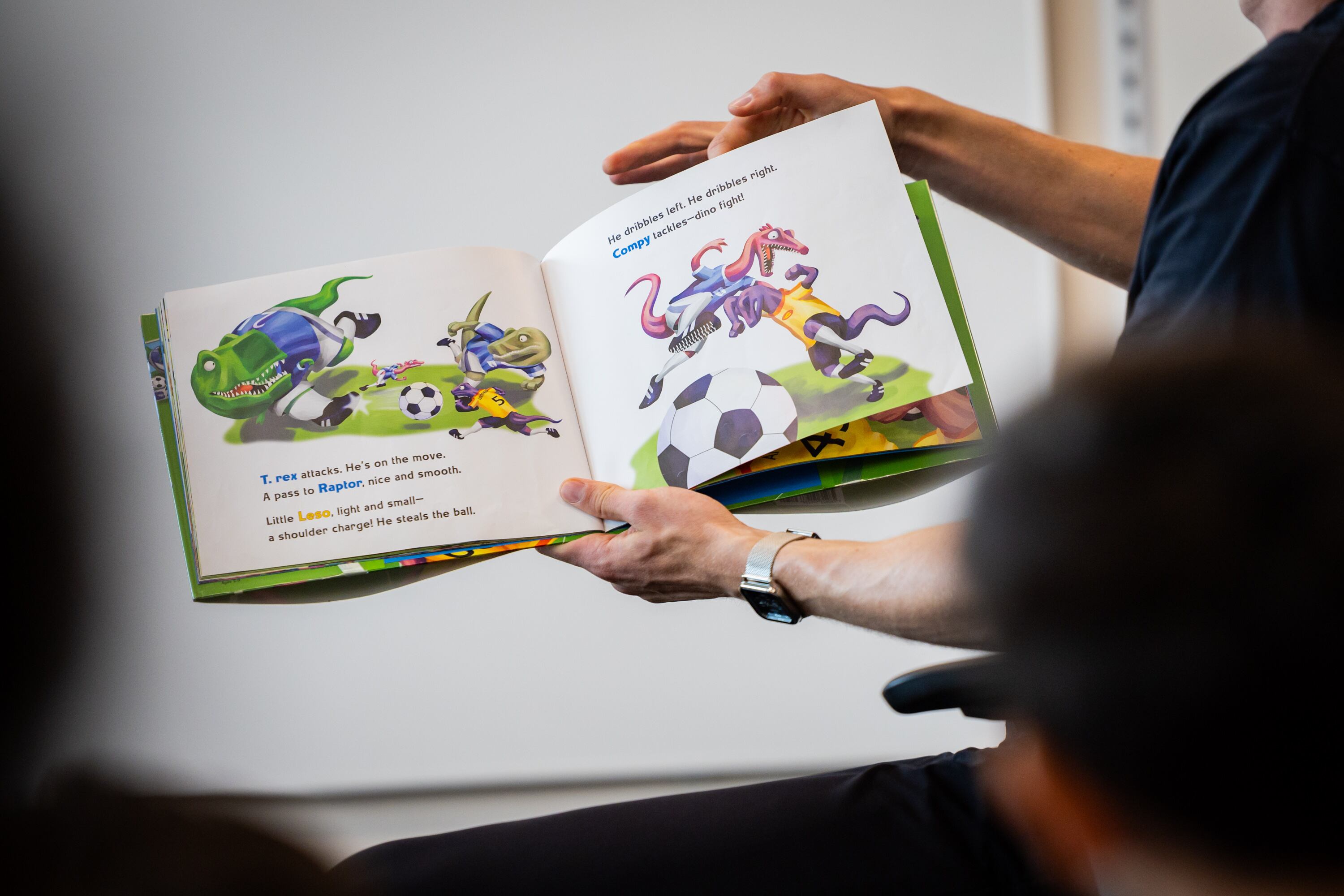 Real Salt Lake player Philip Quinton reads aloud to kindergarten students at Olene Walker Elementary School in South Salt Lake on March 31. A Gardner Institute report said no one assessment accurately tells the story of how well Utah youngsters read.