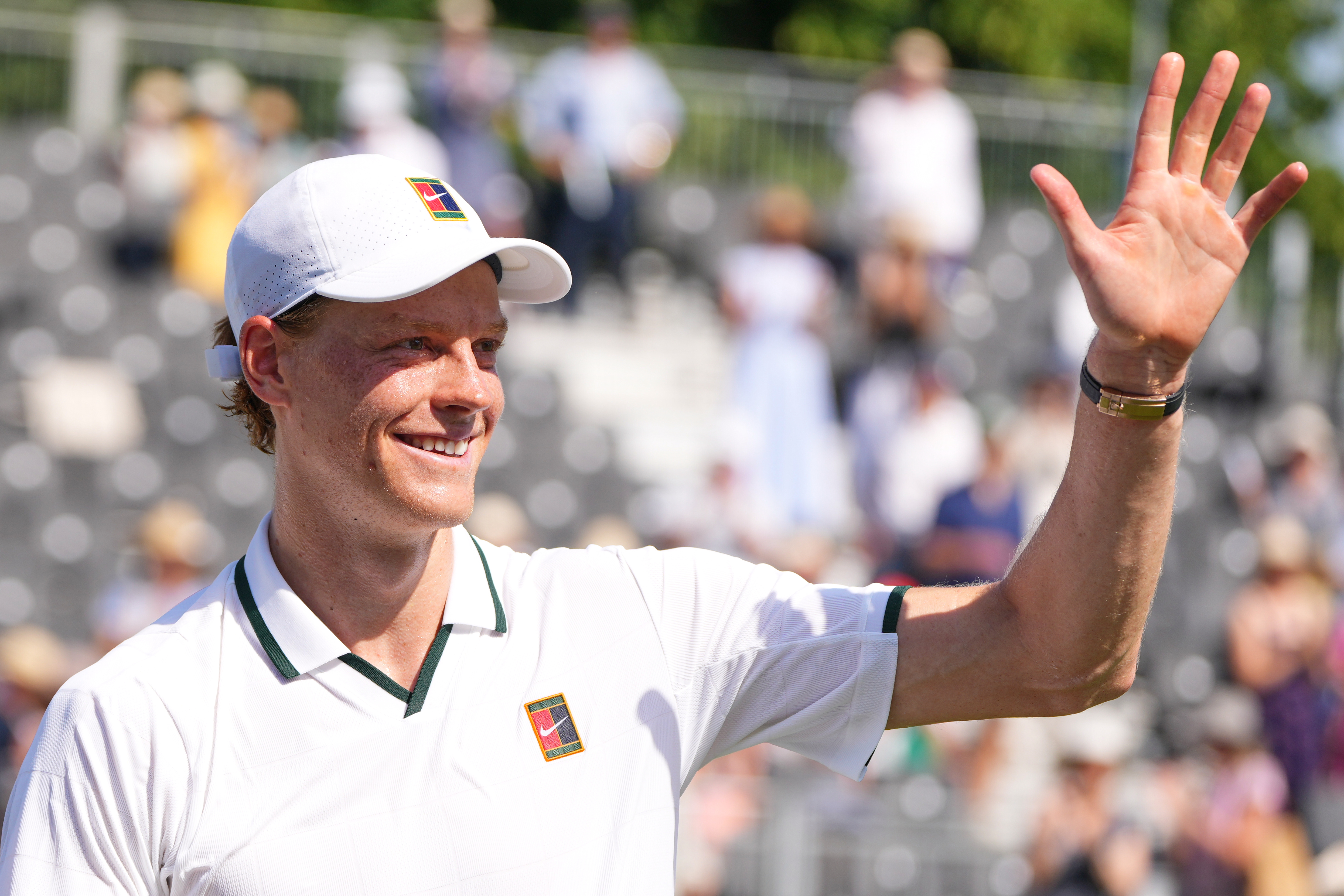 Jannik Sinner of Italy waves to supporters after a tennis exhibition match against Cameron Norrie of Great Britain at the Hurlingham Tennis Club in London, Wednesday, June 24, 2026.