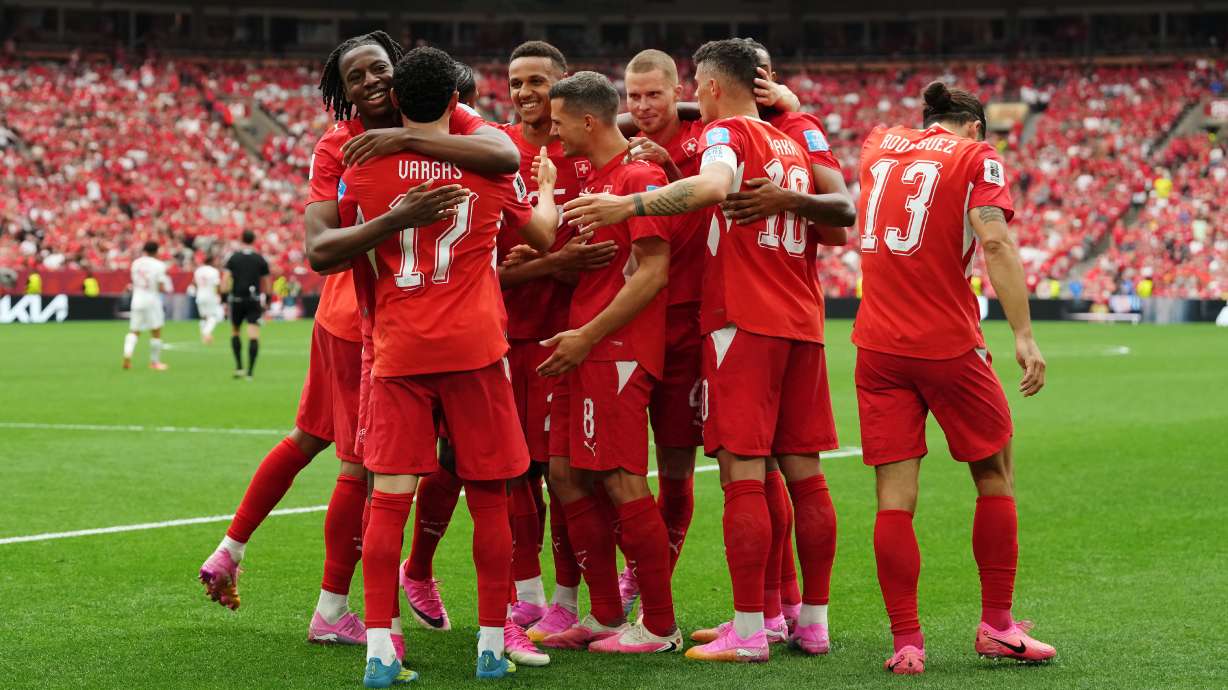 Switzerland's Ruben Vargas (17) is mobbed by teammates after scoring their first goal during the World Cup Group B soccer match between Switzerland and Canada in Vancouver, British Columbia, Wednesday, June 24, 2026.