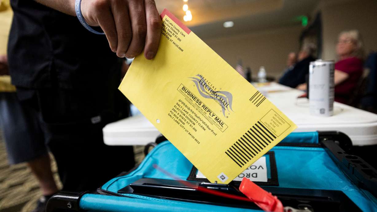 A voter drops a ballot into a drop box during Utah’s primary election at Legacy Village of Provo on Tuesday. Reps. Blake Moore and Celeste Maloy both say their wins in the primaries can serve as a blueprint for other Republicans running in tight races.