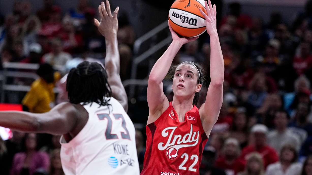 Indiana Fever guard Caitlin Clark (22) shoots over Atlanta Dream forward Sika Kone (23) in the first half of a WNBA basketball game in Indianapolis, Thursday, June 18, 2026.