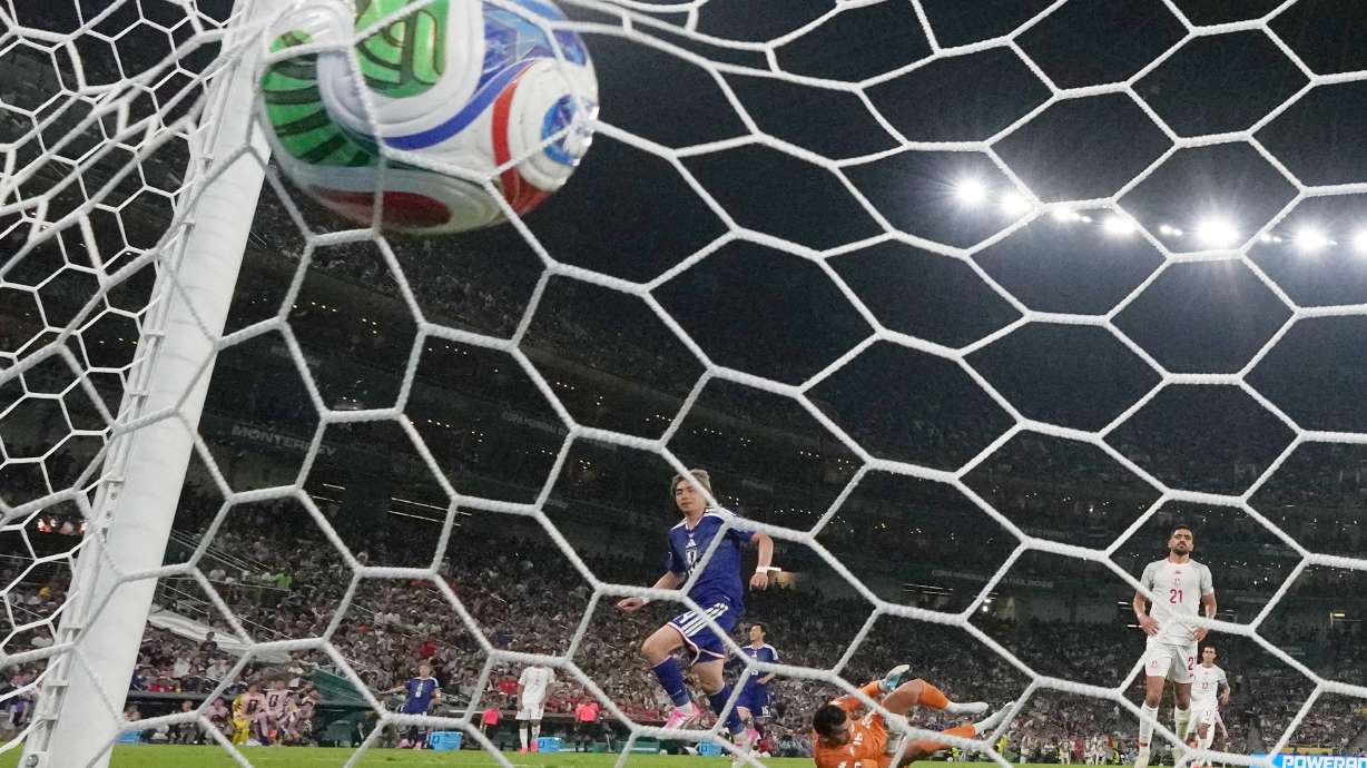 Japan's Junya Ito (14) scores their third goal past Tunisia goalkeeper Aymen Dahmen (16) during the World Cup Group F soccer match between Tunisia and Japan in Guadalupe, near Monterrey, Mexico, Saturday, June 20, 2026.