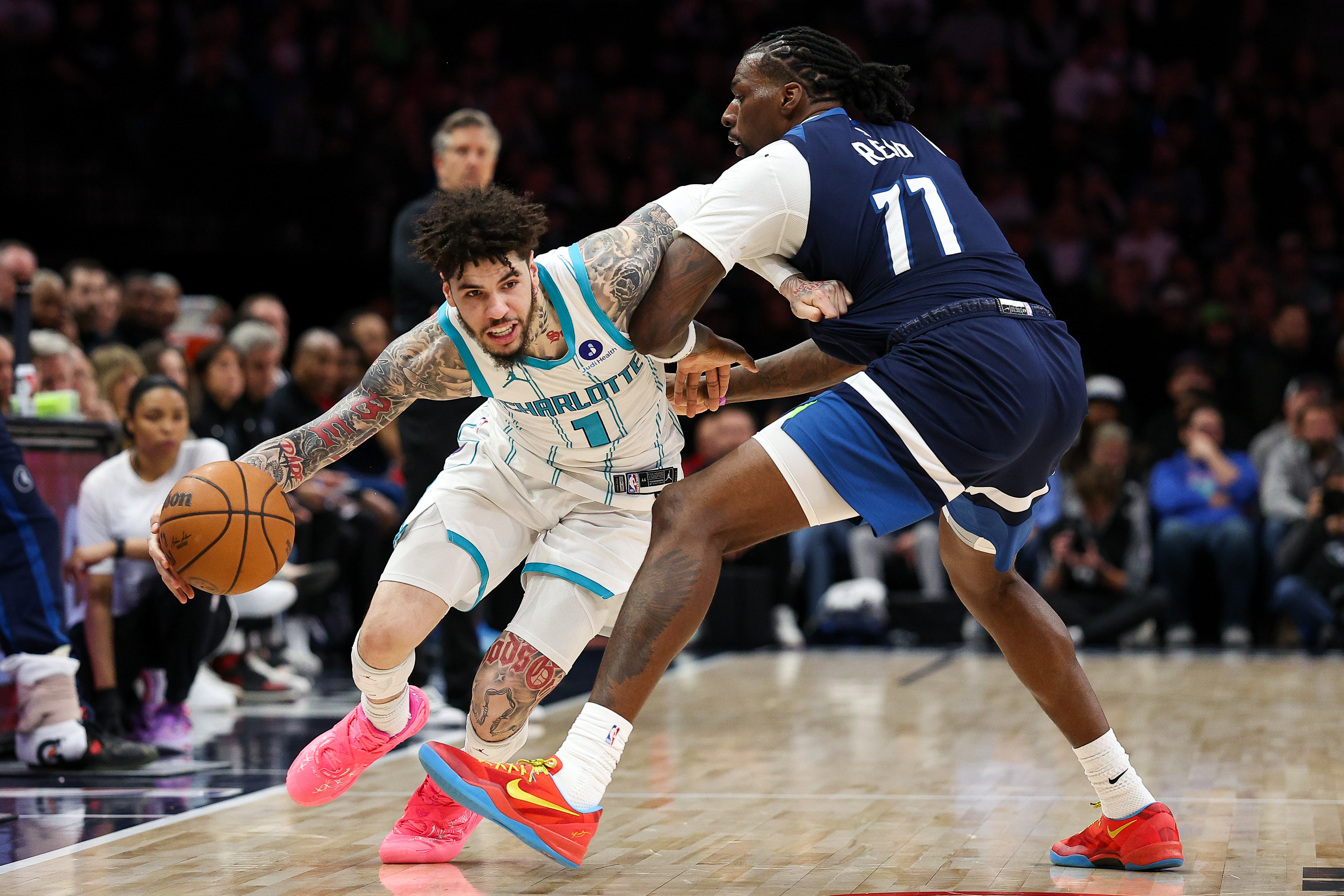 FILE - Charlotte Hornets guard LaMelo Ball (1) works around Minnesota Timberwolves center Naz Reid (11) during the second half of an NBA basketball game, April 5, 2026, in Minneapolis.