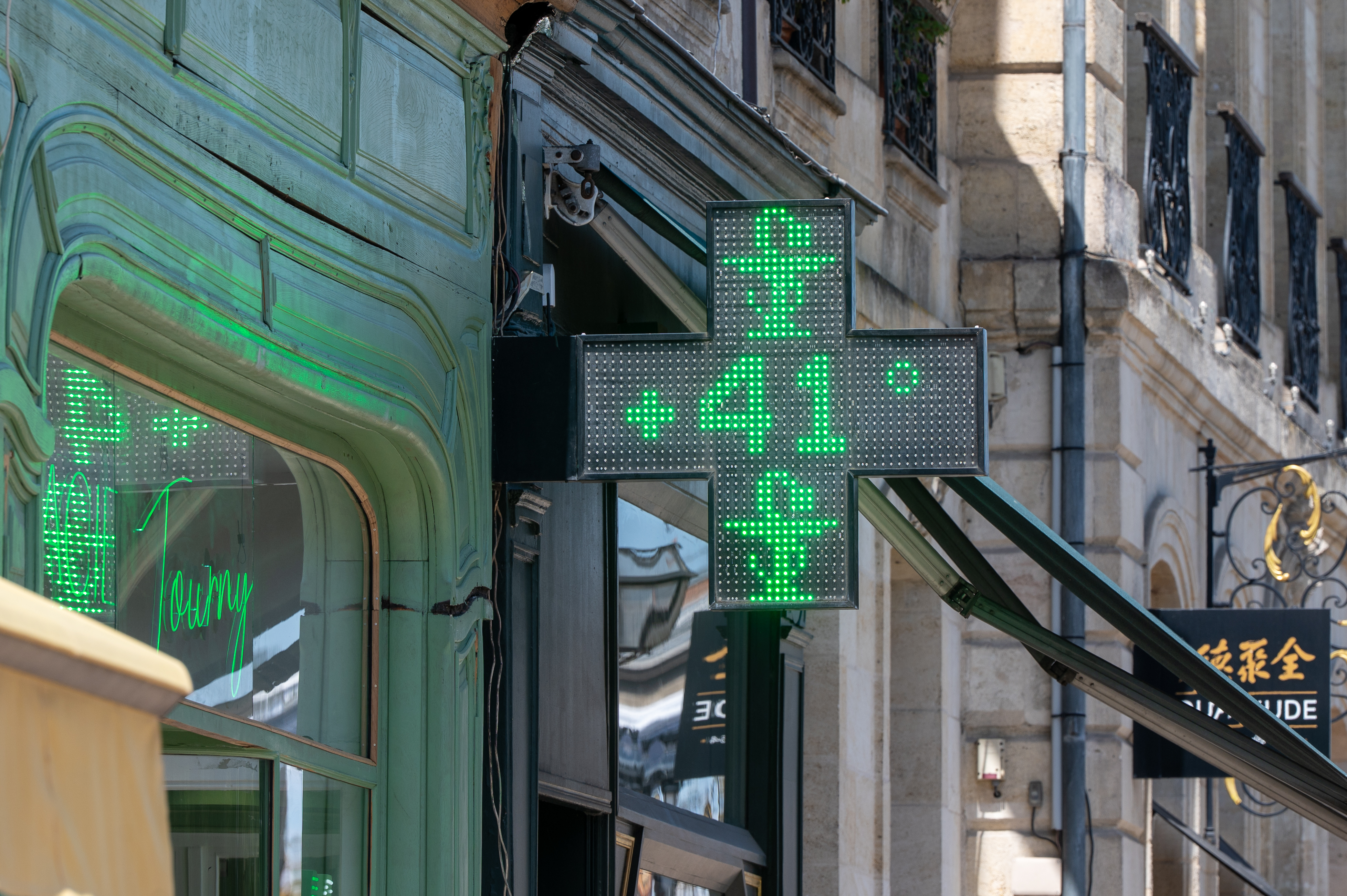 A drugstore sign shows the temperature of 41 degrees Celsius (105,8 degrees Fahrenheit) in Bordeaux, southwestern France, on Tuesday, June 23, 2026, as the national weather service, Meteo France, placed 54 departments, about half the country, under a red heat wave alert.