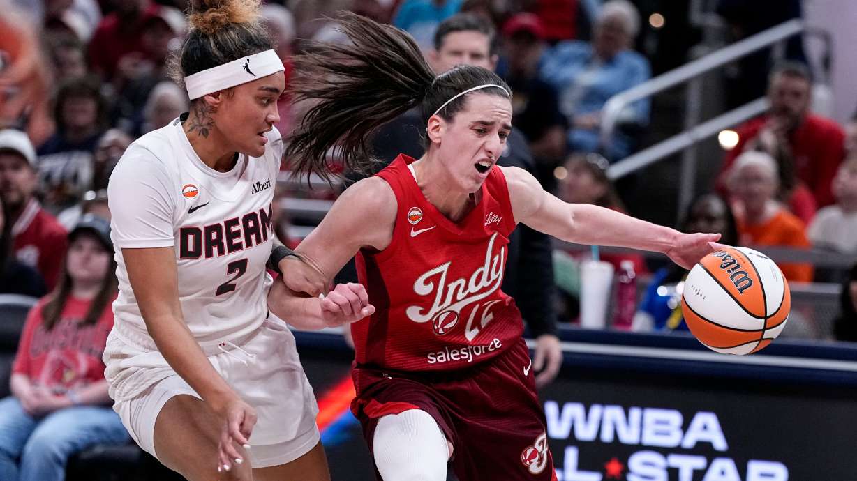 Indiana Fever guard Caitlin Clark (22) drives on Atlanta Dream guard Te-Hina Paopao (2) in the first half of a WNBA basketball game in Indianapolis, Thursday, June 18, 2026.