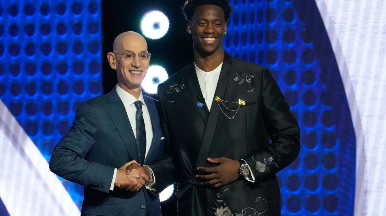 AJ Dybantsa, right, poses for a photo with NBA commissioner Adam Silver, left, after being selected by the Washington Wizards as the first pick in the first round of the NBA basketball draft, Tuesday, June 23, 2026, in New York.