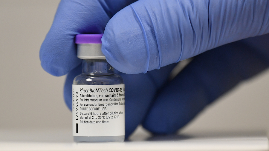 CARDIFF, WALES - DECEMBER 08: A member of staff poses with a phial of Pfizer-BioNTech Covid-19 vaccine at a vaccination health centre on the first day of the largest immunisation programme in the UK's history on December 8, 2020 in Cardiff, United Kingdom. Wales joined the other UK nations in rolling out the covid-19 vaccine on Tuesday, a rare moment of coordination after months of disjointedness in the four nations' pandemic response. Wales introduced a 17-day "firebreak" lockdown in October and November to suppress the surge in covid-19 cases, but infections have continued to rise.