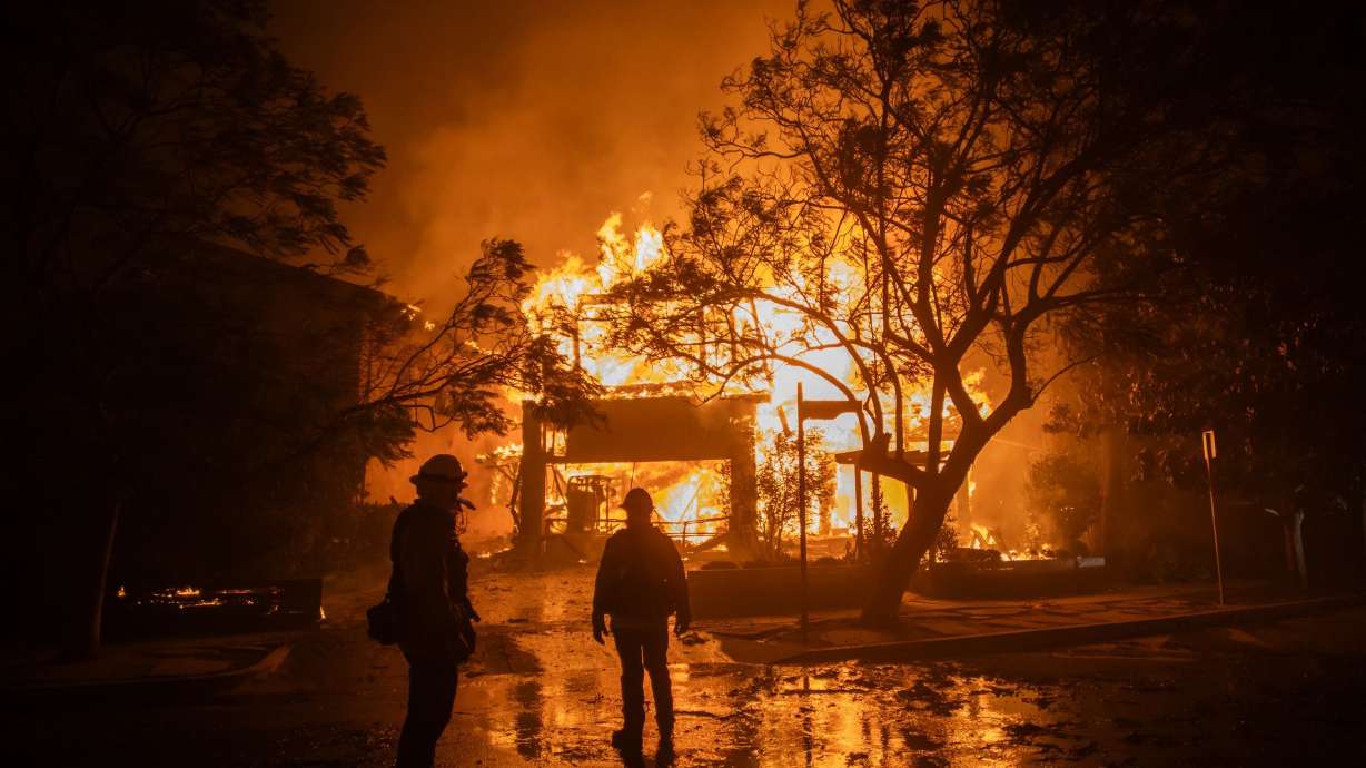Firefighters watch the flames from the Palisades Fire burning a home on Jan. 8, 2015, in Los Angeles. Jurors in the federal trial of Palisades Fire suspect Jonathan Rinderknecht have concluded their second day of deliberations and will return Friday