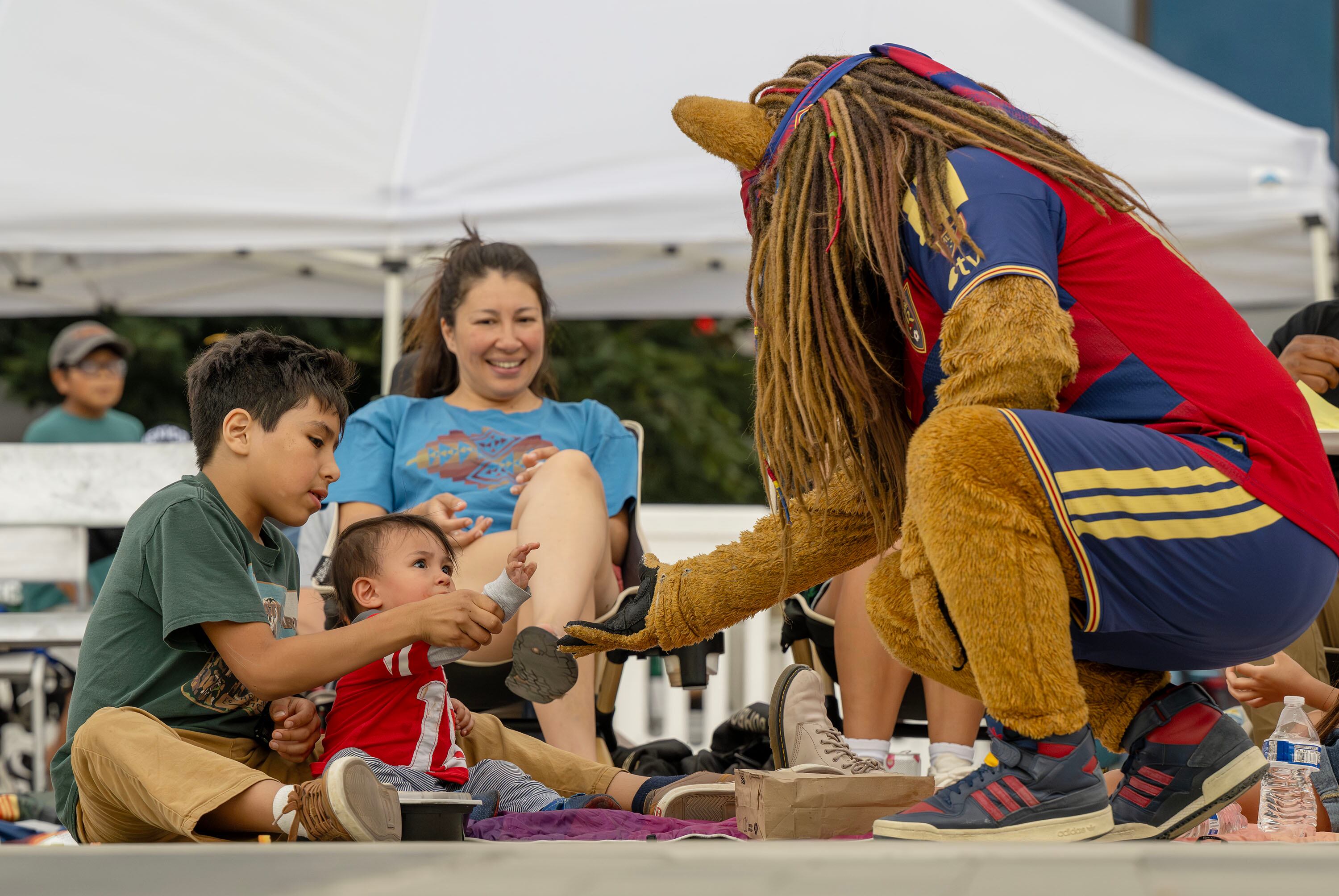 Real Salt Lake’s mascot, Leo the Lion, tries to make friends with some young fans at Millcreek Common as soccer fans gather to watch Mexico and the Czech Republic play in the World Cup on Wednesday. Soccer's popularity in the U.S. continues to rise, but still lags behind other sports.