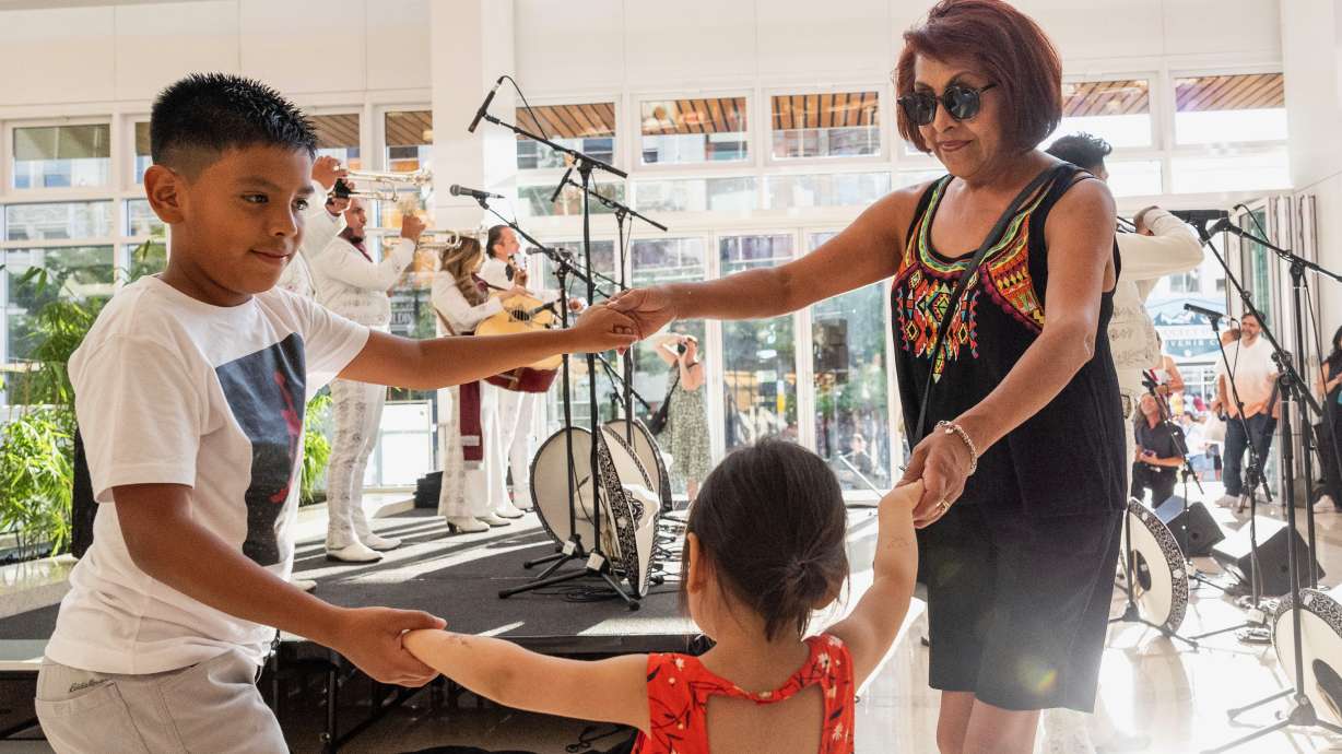 Latinos accounted for nearly half of Utah's overall population growth between 2020 and 2025. In the July 19, 2024, photo, Rose Olivas dances with her grandchildren, Jameson Olivas, 8, and Elisabella, 3, during the Mariachi Festival in Salt Lake City.