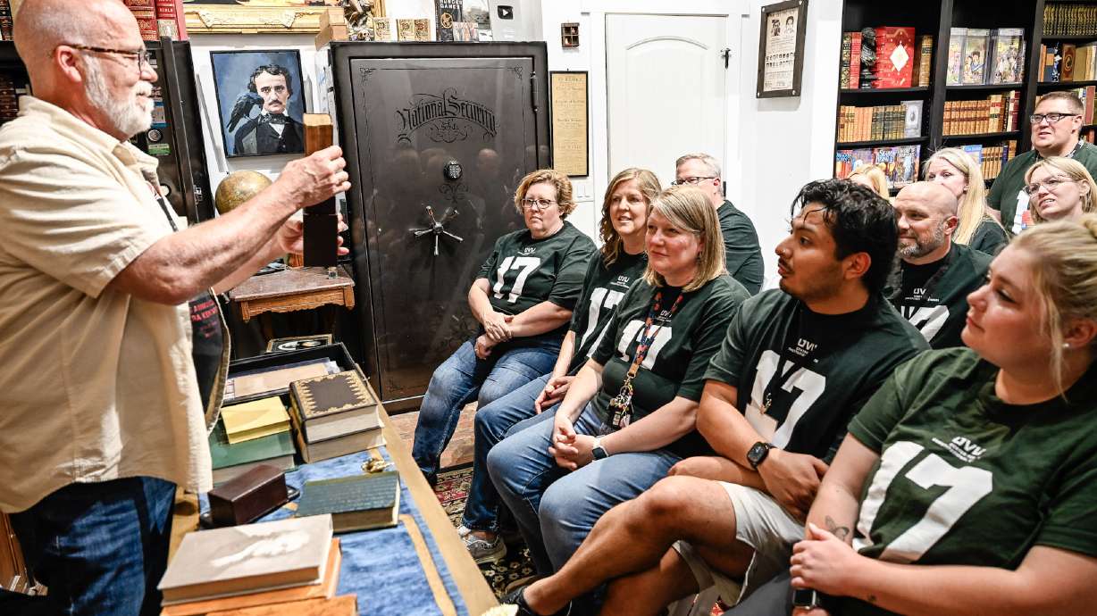 A group of teachers learning history facts at Moons Rare Books in Provo.