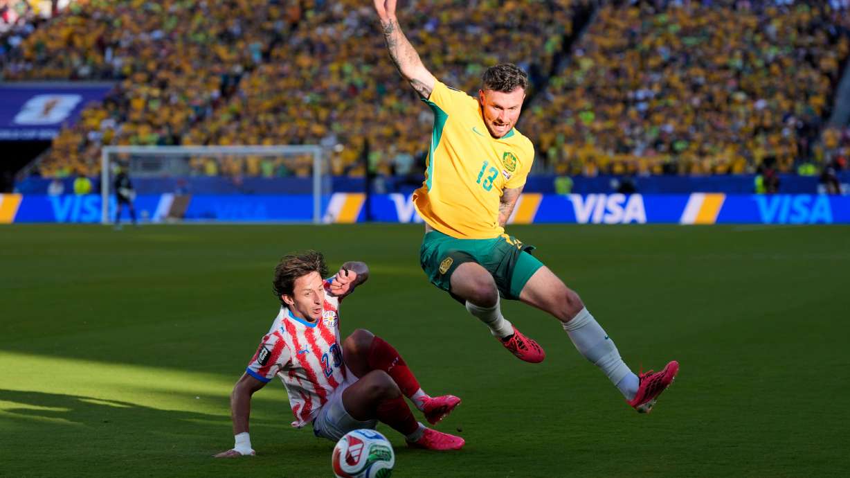 Australia's Aiden O'Neill (13) battles for the ball with Paraguay's Matias Galarza (23) during the World Cup Group D soccer match between Paraguay and Australia in Santa Clara, Calif., near San Francisco, Thursday, June 25, 2026.