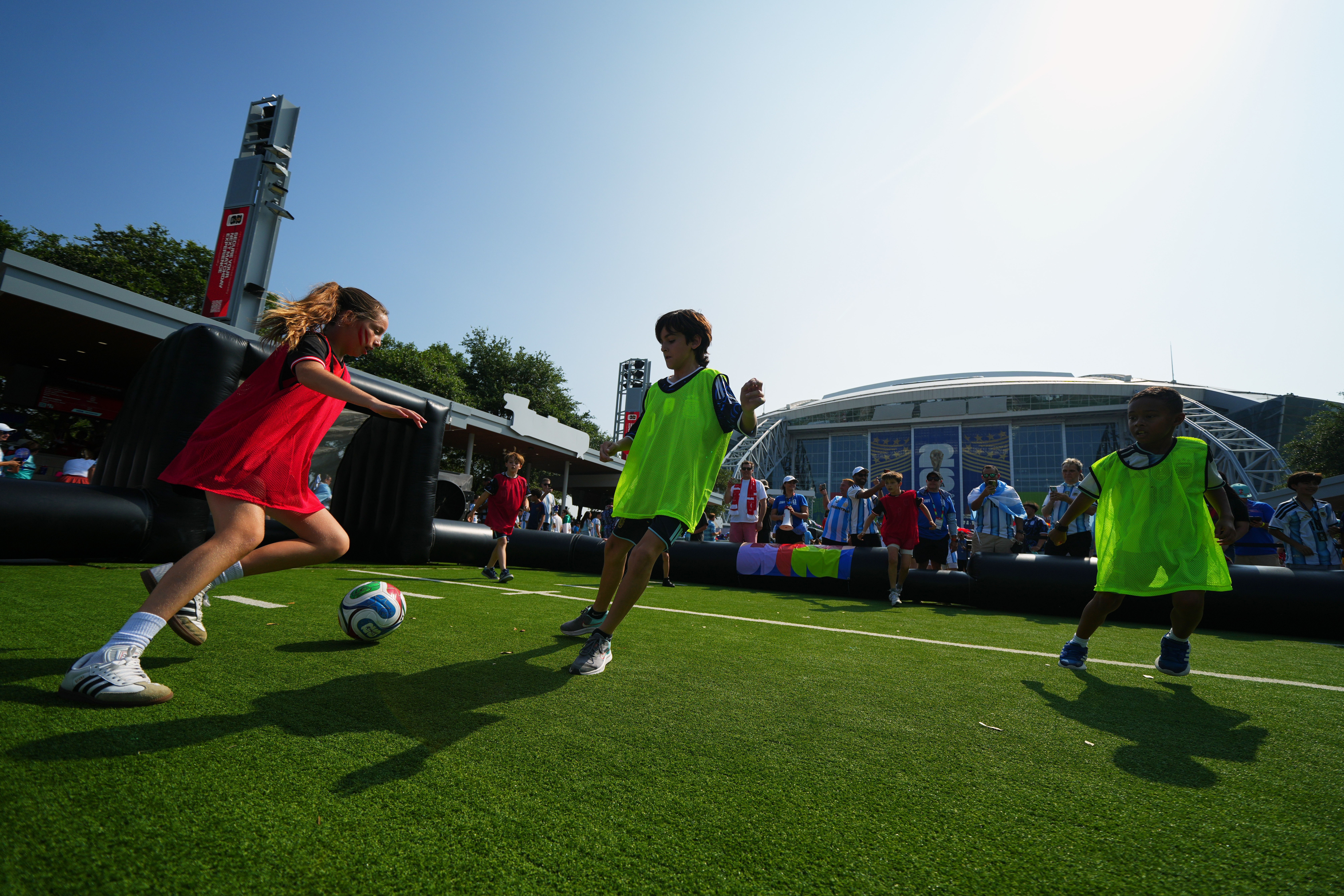 FILE - Children wearing shirts of Austria and Argentina play soccer outside the stadium before the World Cup Group J soccer match between Argentina and Austria in Arlington, Texas, near Dallas, Monday, June 22, 2026. 