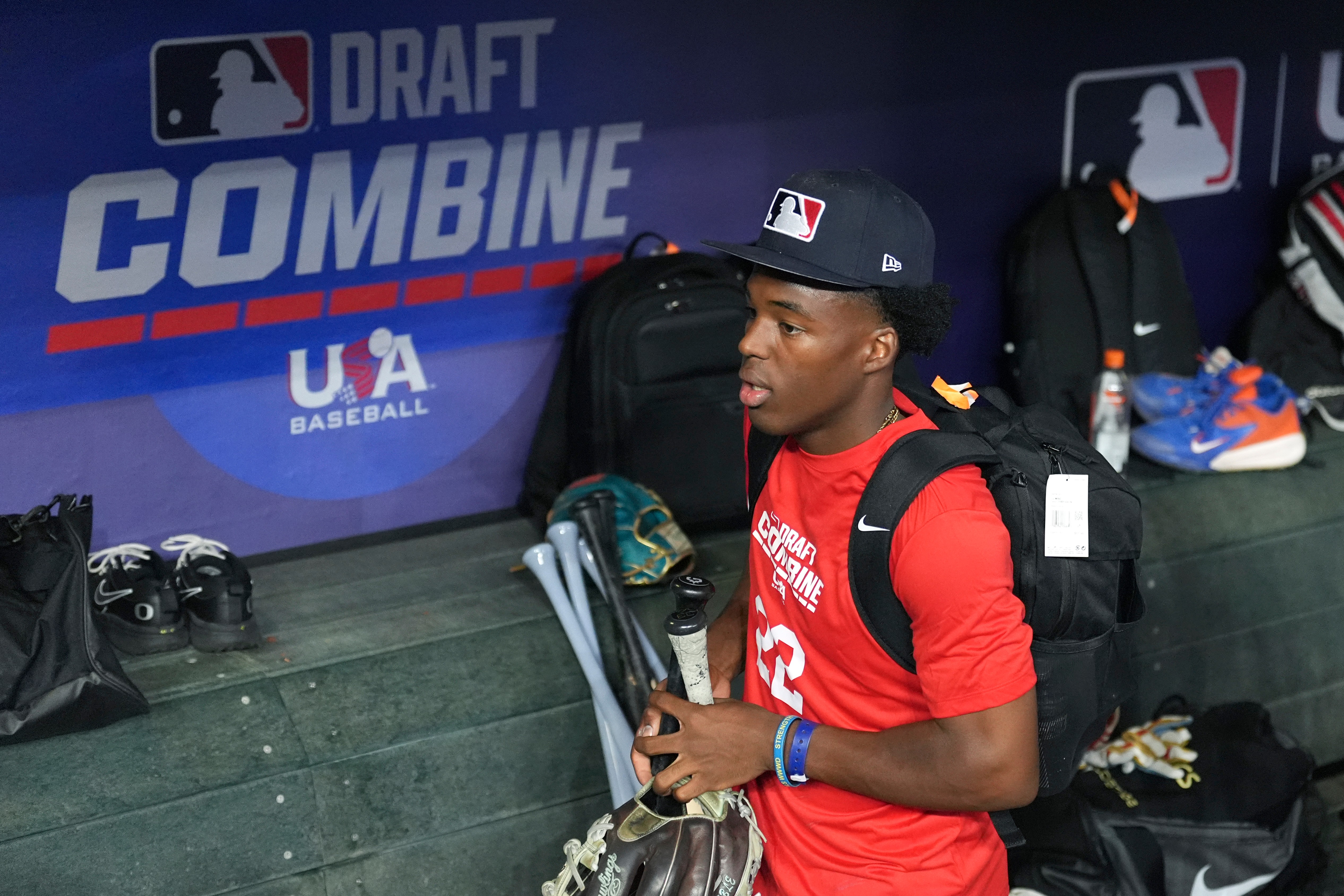 James Clark, a shortstop from St. John Bosco High School, gathers his gear in the dugout at the MLB baseball combine in Phoenix, Tuesday, June 23, 2026. 