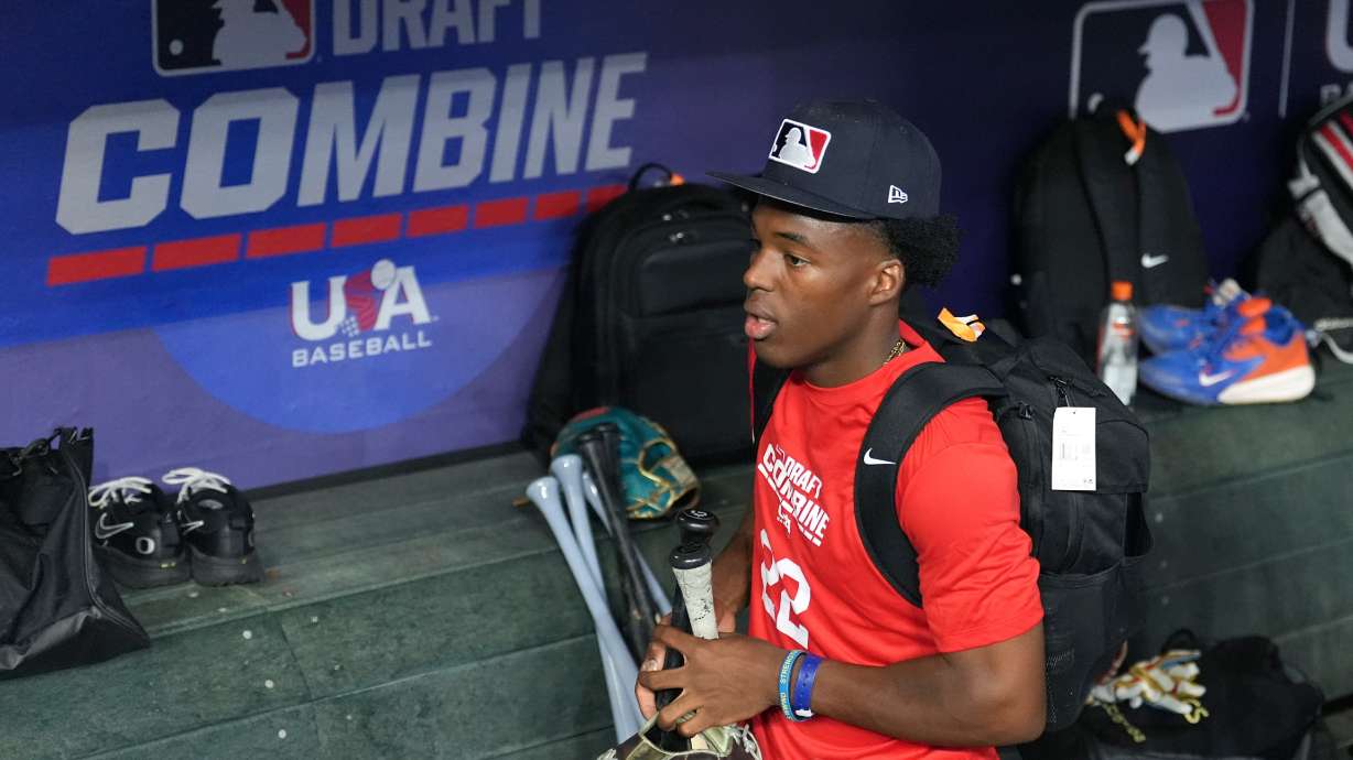James Clark, a shortstop from St. John Bosco High School, gathers his gear in the dugout at the MLB baseball combine in Phoenix, Tuesday, June 23, 2026.