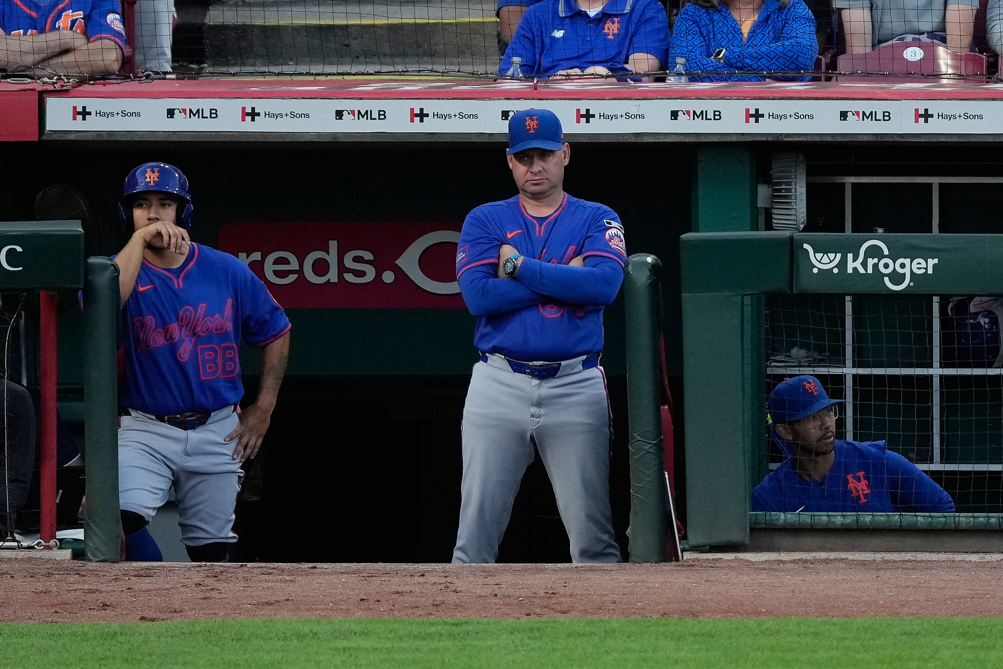 New York Mets manager Carlos Mendoza center, looks out from the dugout during the fourth inning of a baseball game against the Cincinnati Reds in Cincinnati, Monday, June 15, 2026. 