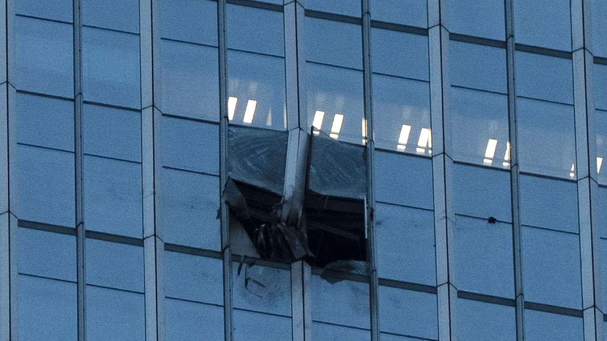 The surface of the CITIC Tower, also known as Zun Tower, is damaged in Beijing, Friday. Roads around the tower were closed and police stopped passersby from filming.