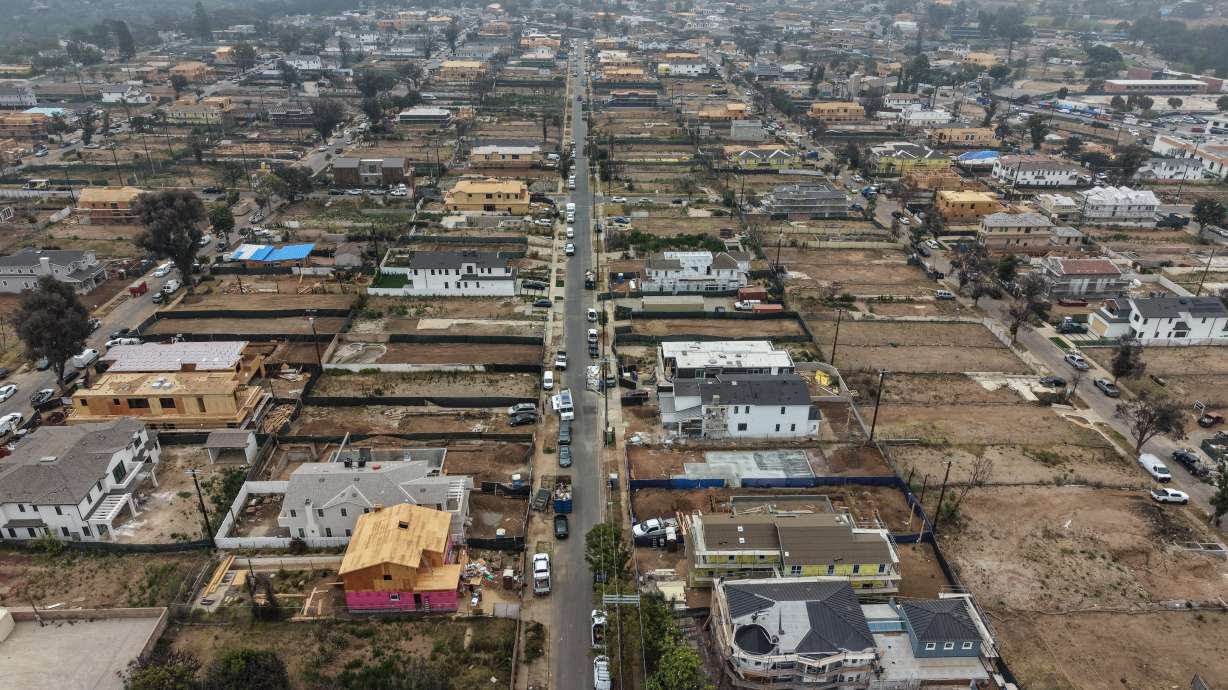 An aerial view shows homes under construction amid empty lots more than a year after the Palisades Fire in the Pacific Palisades neighborhood of Los Angeles, June 4. A mistrial was declared in the arson trial over the fire on Friday.