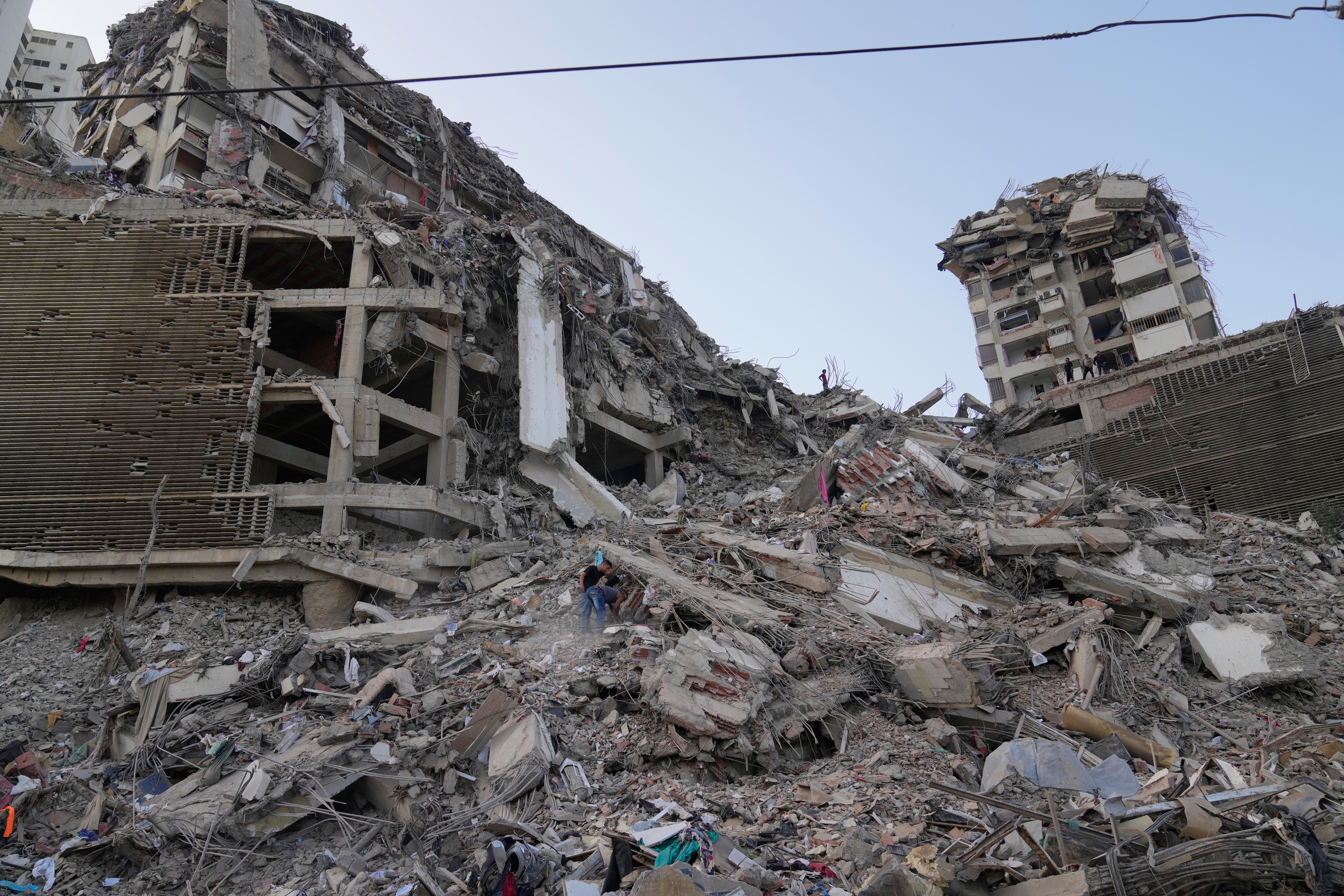 Residents search through the rubble two days after an earthquake struck La Guaira, Venezuela, Friday. International aid began arriving in the area and will continue through the weekend.