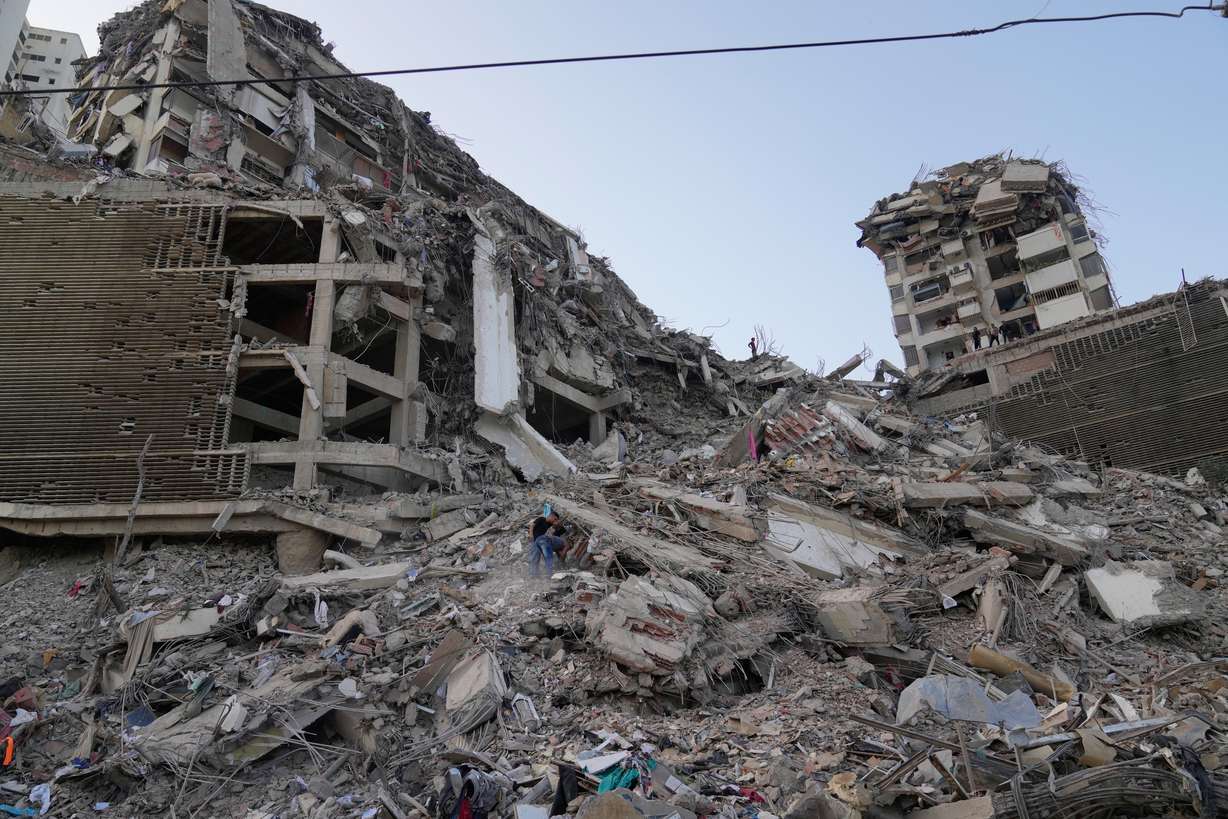 Residents search through the rubble two days after an earthquake struck La Guaira, Venezuela, Friday. International aid began arriving in the area and will continue through the weekend.