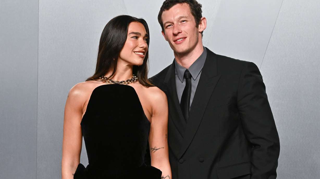 FILE - Dua Lipa, left, and Callum Turner arrive at the Vanity Fair Oscar Party on Sunday, March 15, 2026, at the Los Angeles County Museum of Art in Los Angeles.