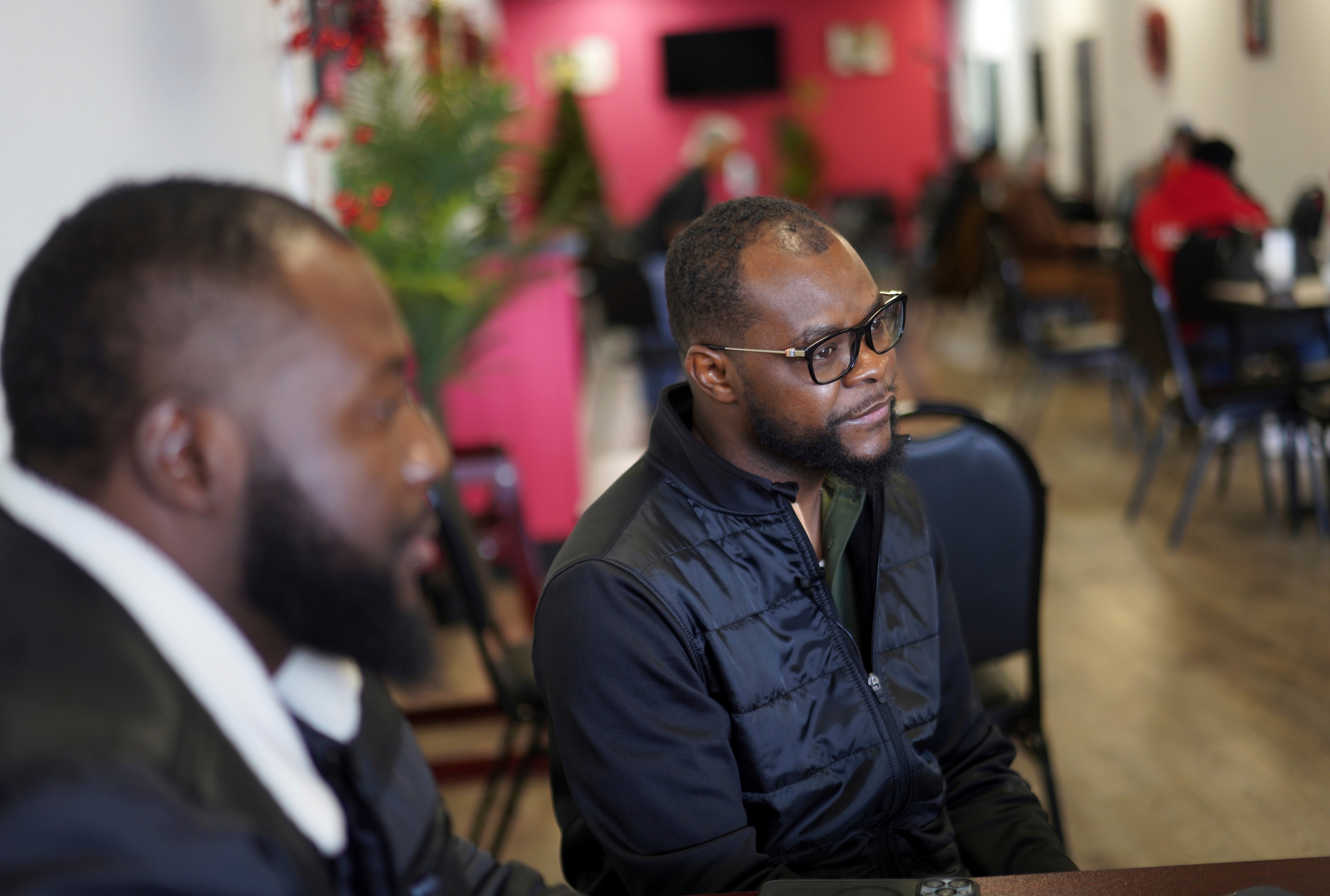 Viles Dorsainvil, executive director of the Haitian Community Help and Support Center at Rose Goute Creole Restaurant, sits with interpreter James Fleurijean, left, a board member of the Haitian Community Help and Support Center, in Springfield, Ohio, Jan. 25, 2025.