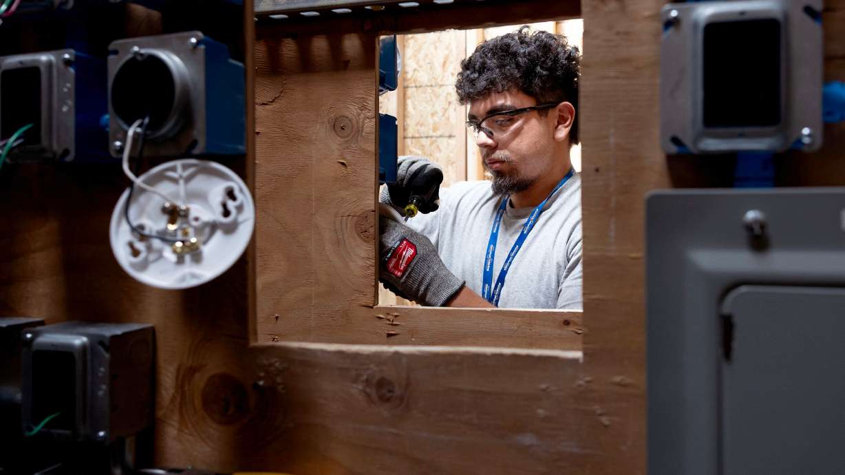 Cristian Rosas practices wiring switches and lights during class at the Utah Technical Training Alliance in West Jordan on Friday. Rep. Burgess Owens is touting apprenticeships like this as educational options.