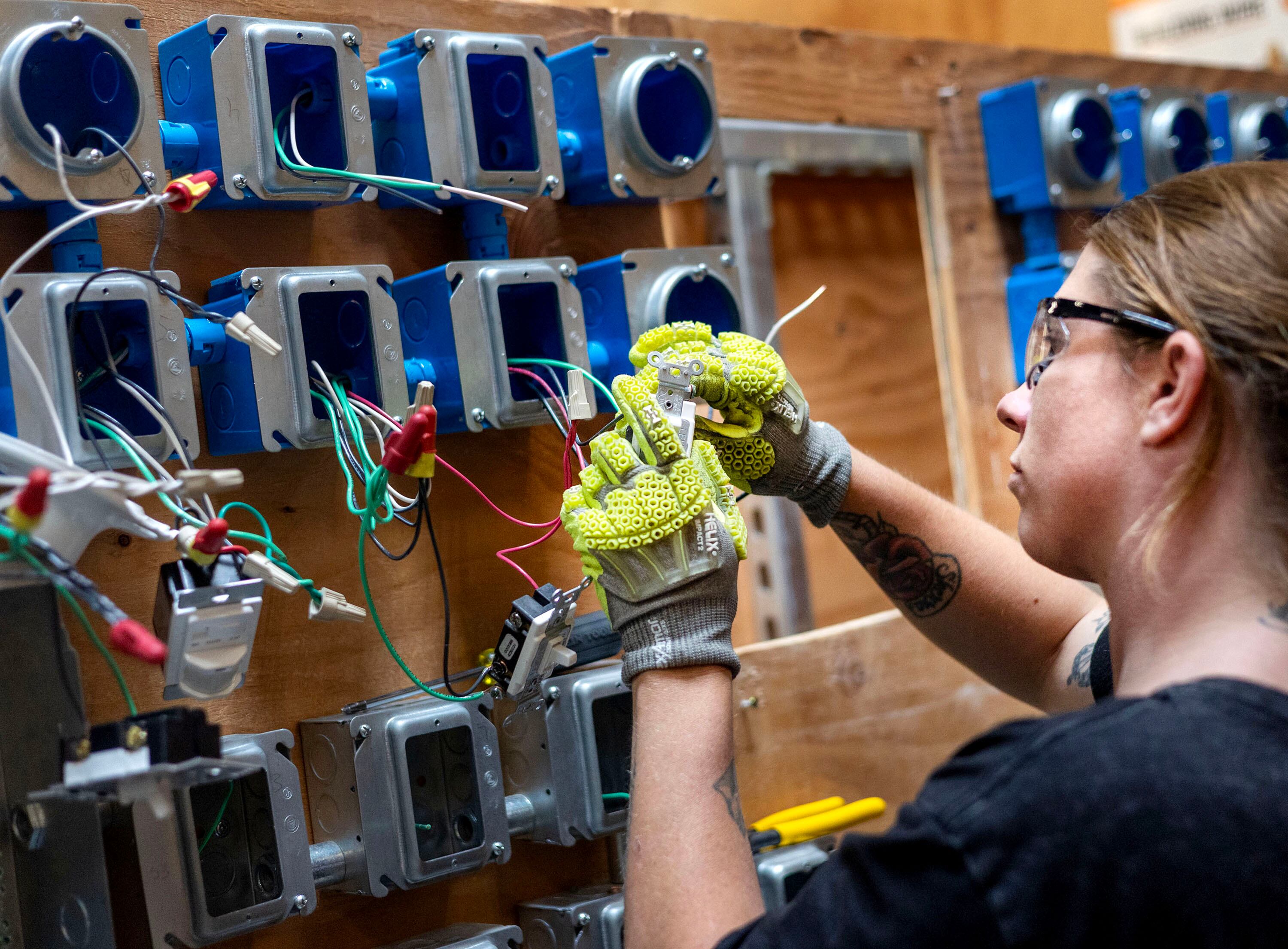 Kinzie Taylor practices wiring three-way switches at the Utah Technical Training Alliance in West Jordan on Friday. Witnesses at a House subcommittee meeting on Wednesday advocated for more learning opportunities like these.