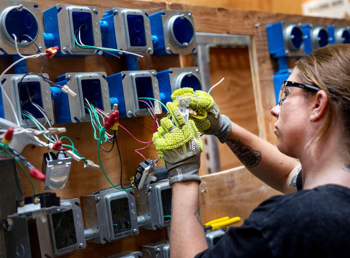 Kinzie Taylor practices wiring three-way switches at the Utah Technical Training Alliance in West Jordan on Friday. Witnesses at a House subcommittee meeting on Wednesday advocated for more learning opportunities like these.