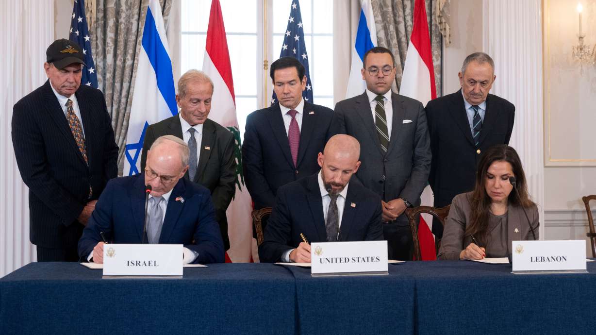 Secretary of State Marco Rubio and others watch Israel's Ambassador to the U.S. Yechiel Leiter, counselor Dan Holler and Lebanon's Ambassador to the U.S. Nada Hamadeh sign a framework agreement at the State Department, Friday in Washington. The agreement was seen as a "first step" for peace.