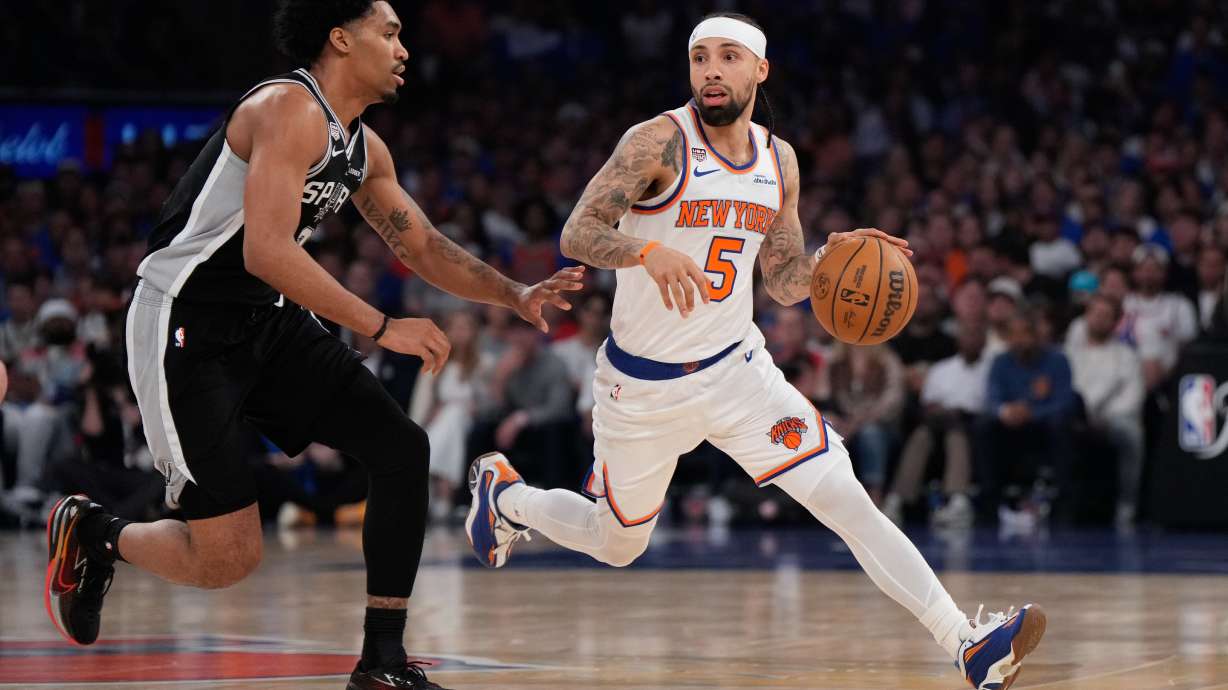 New York Knicks guard Jose Alvarado (5) drives as San Antonio Spurs guard Dylan Harper defend during the first half of Game 4 of the NBA Finals basketball series, Wednesday, June 10, 2026, in New York.
