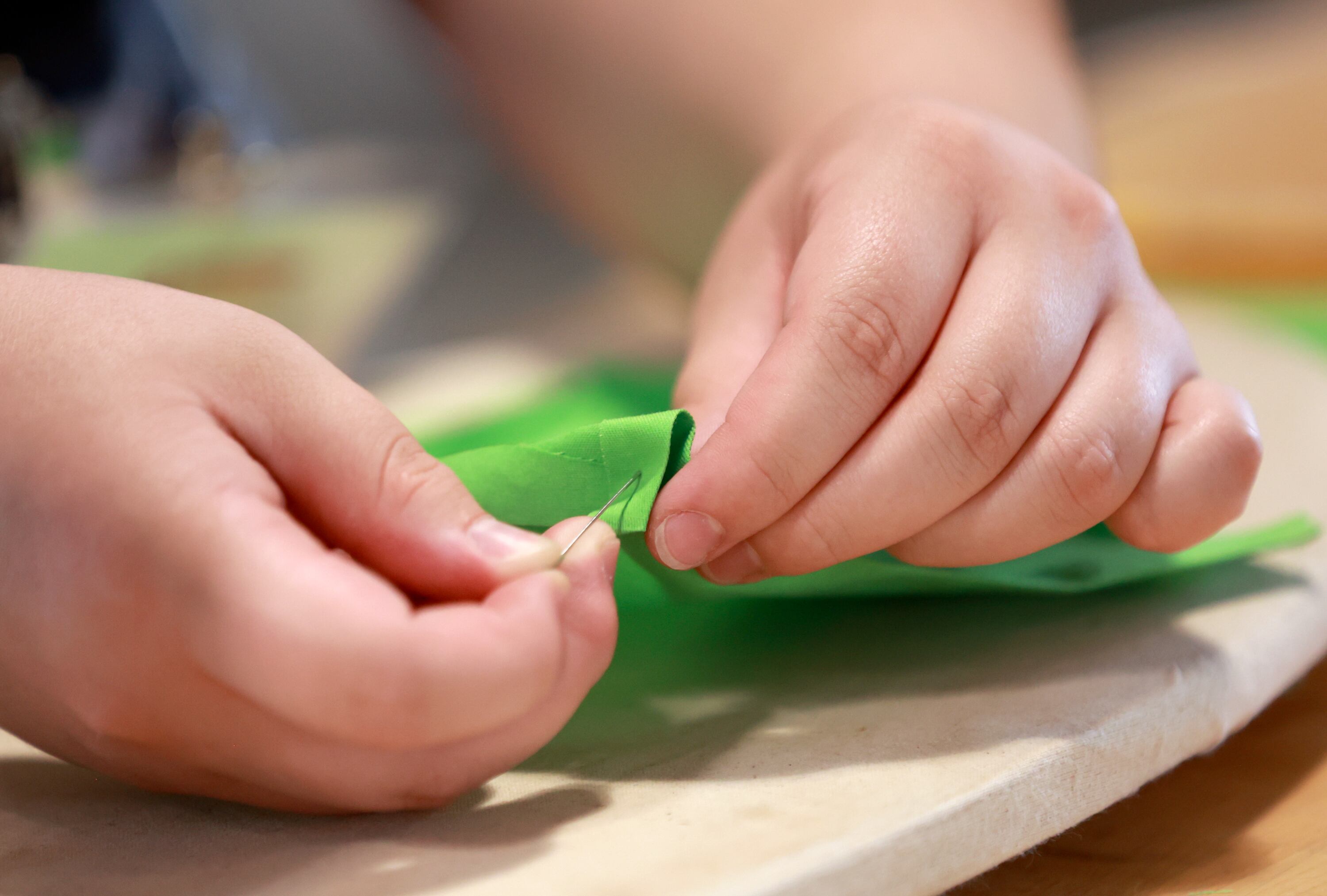 Brooklyn Thomas, 16, of Tooele, sews an apron for a restaurant she hopes to open at Lassonde Startup Academy at the University of Utah’s Lassonde Studios in Salt Lake City on Monday. Lassonde Executive Director Scott Holley saluted the broad unicorn-producing ecosystem found across the state.