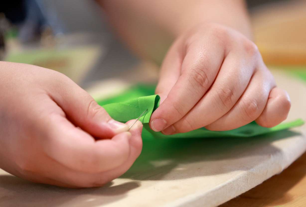 Brooklyn Thomas, 16, of Tooele, sews an apron for a restaurant she hopes to open at Lassonde Startup Academy at the University of Utah’s Lassonde Studios in Salt Lake City on Monday. Lassonde Executive Director Scott Holley saluted the broad unicorn-producing ecosystem found across the state.