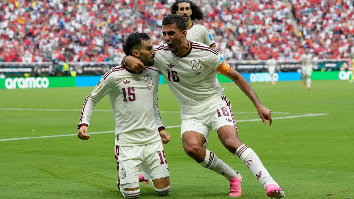 Spain's Alex Baena, left, is congratulated after scoring his side's opening goal by Rodri during the World Cup Group H soccer match between Uruguay and Spain in Zapopan, near Guadalajara, Mexico, Friday, June 26, 2026.